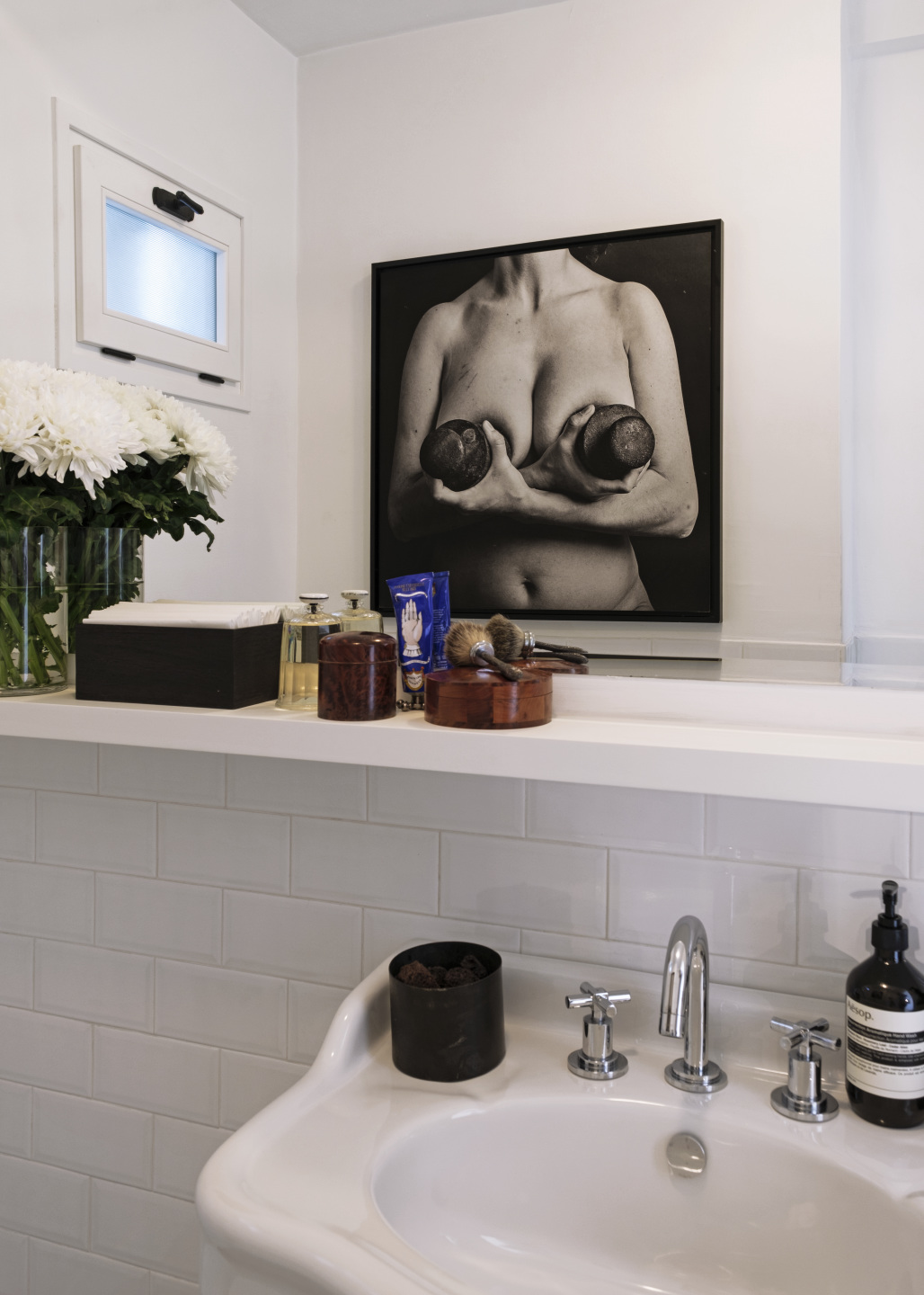 Black and white portrait of a human chest in the bathroom of the home.