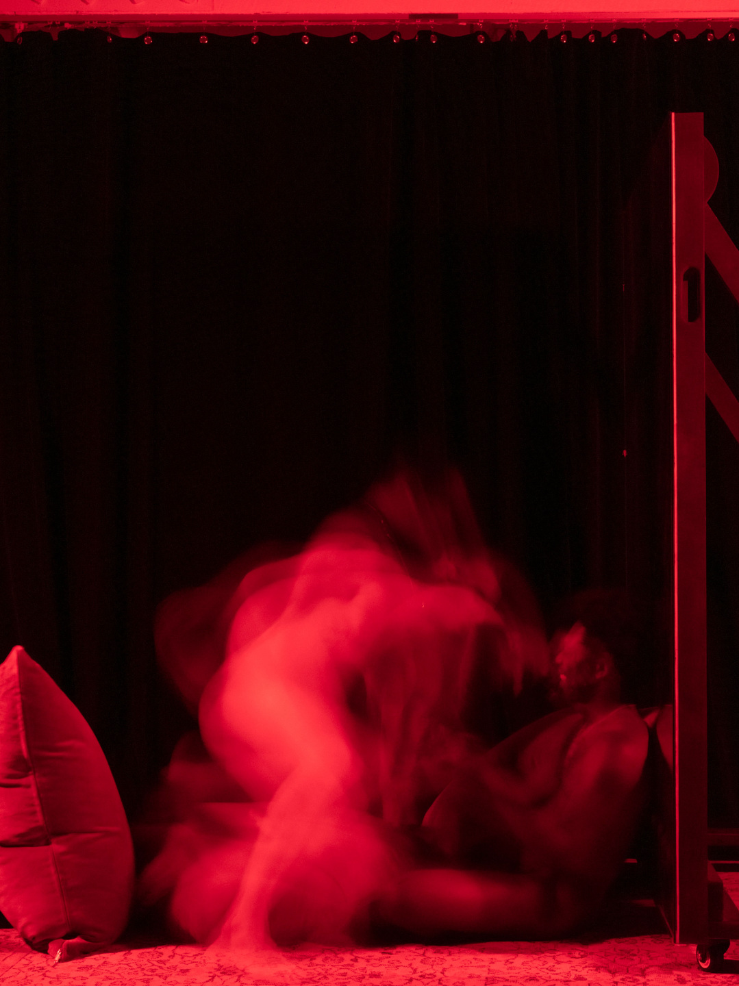 Blurred motion photographed in dark room with red lighting