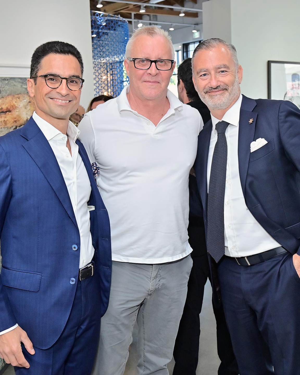 three men pose together