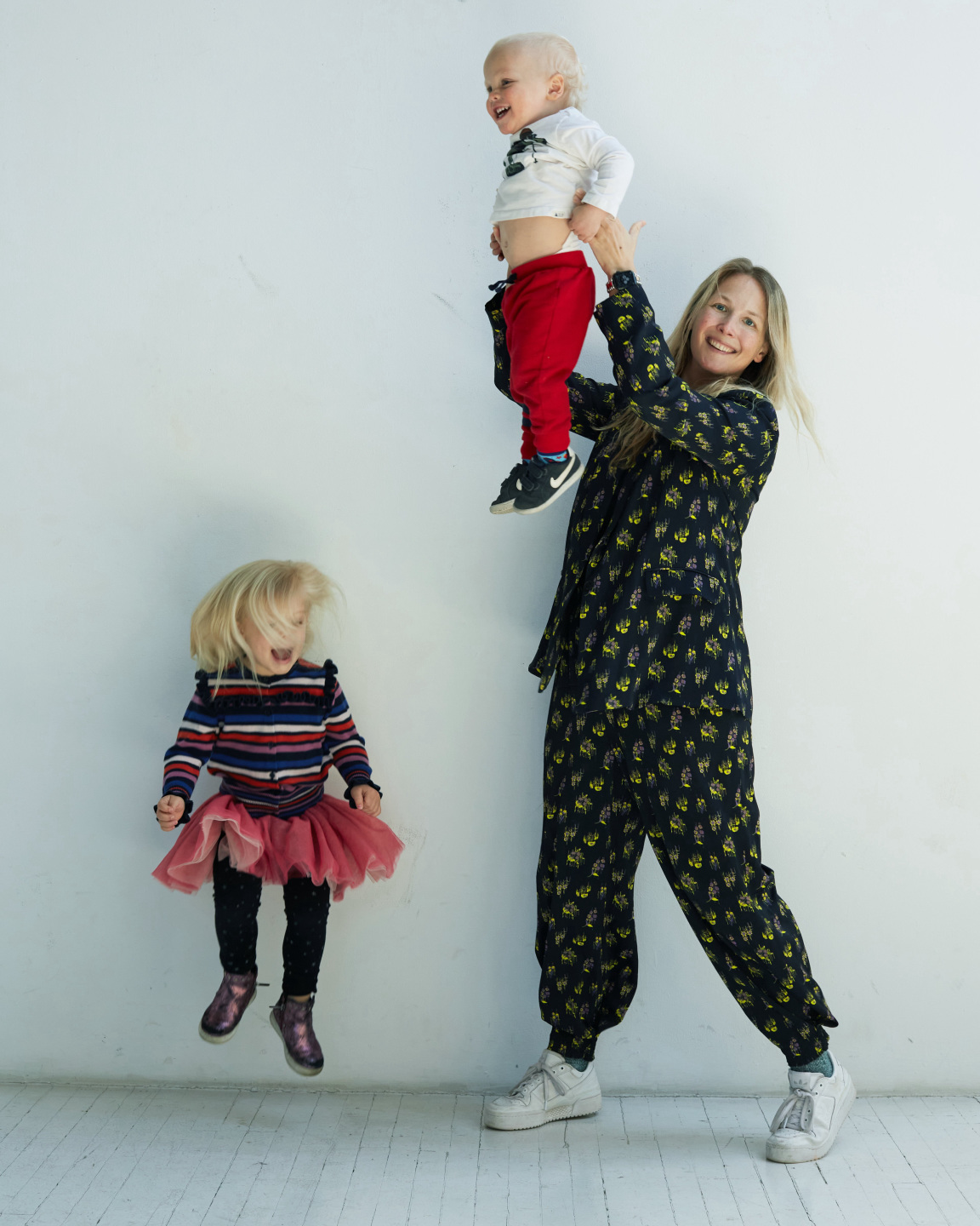 mom and kids jumping