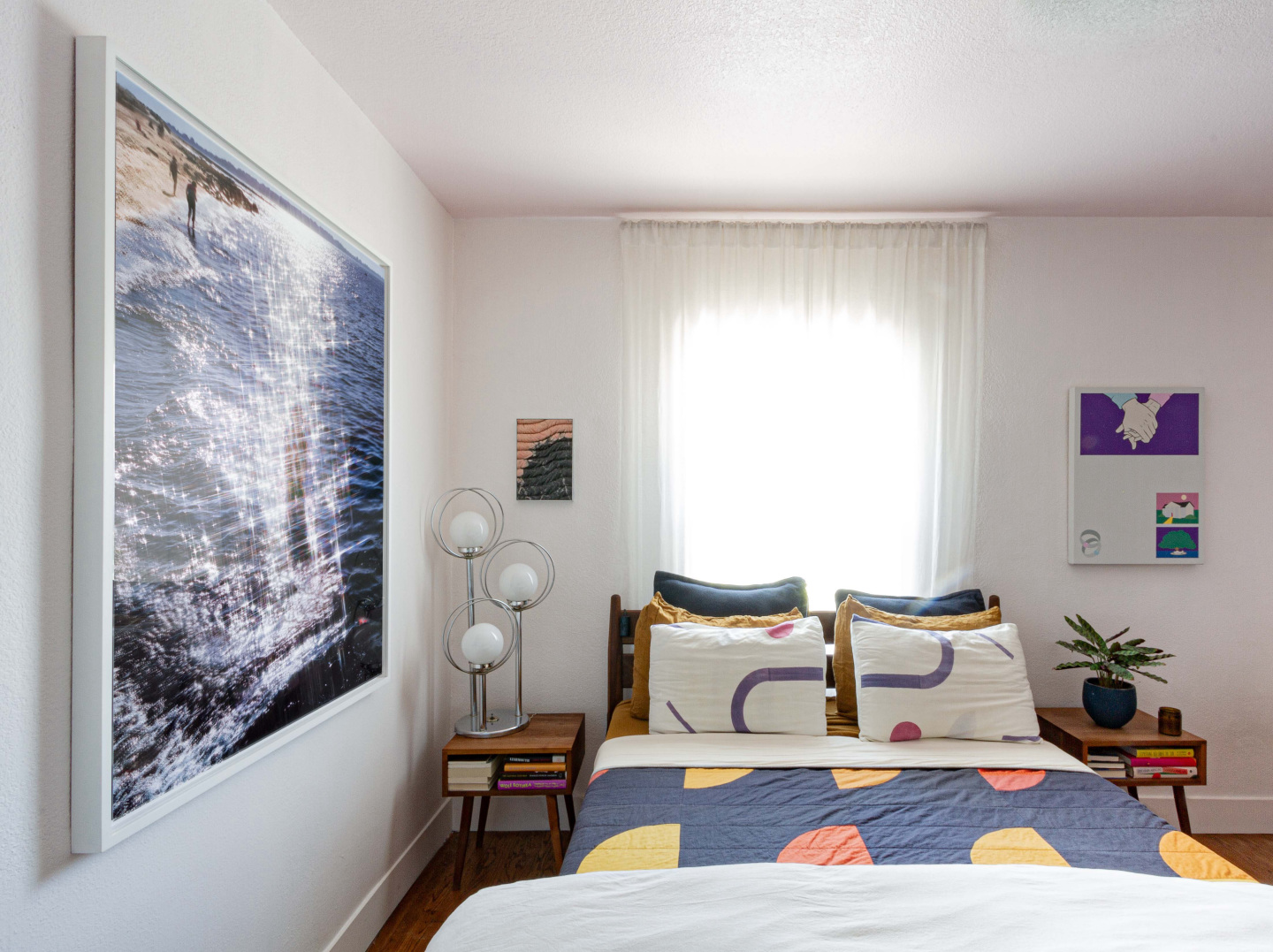 Artworks decorating the walls of a bedroom.