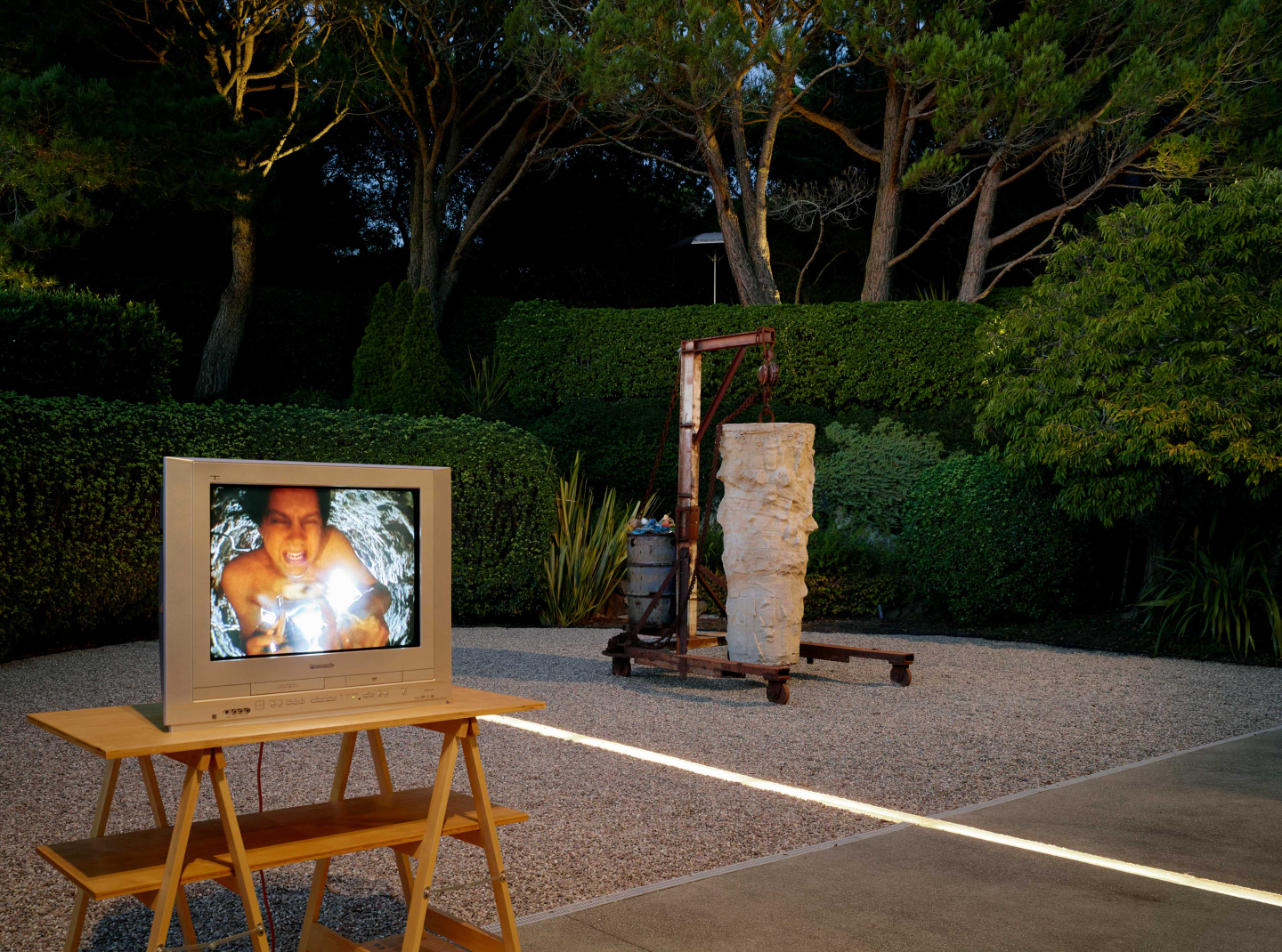sculpture with tv in yard