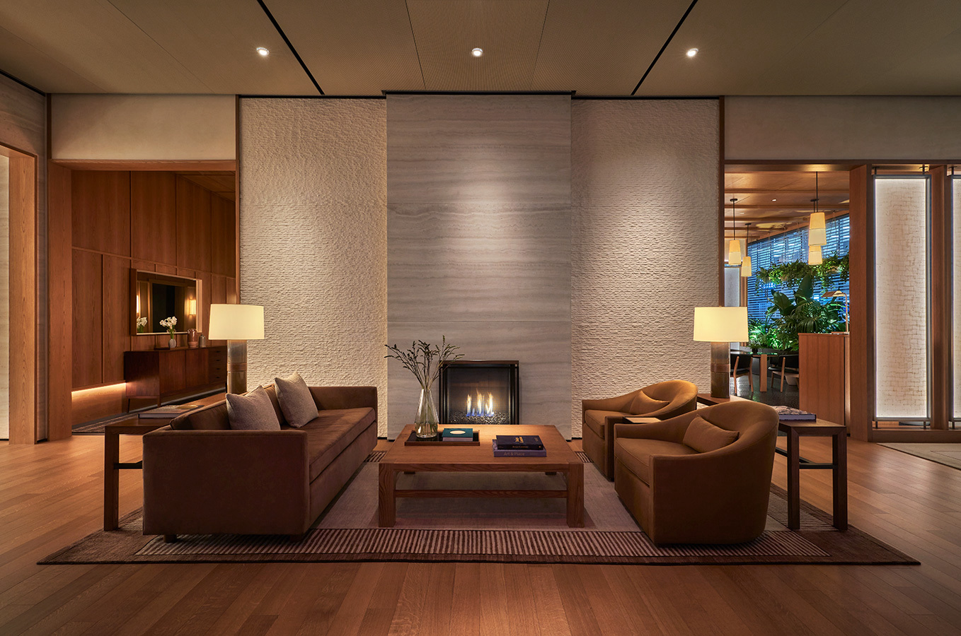 A hotel lobby with a fireplace and seating.
