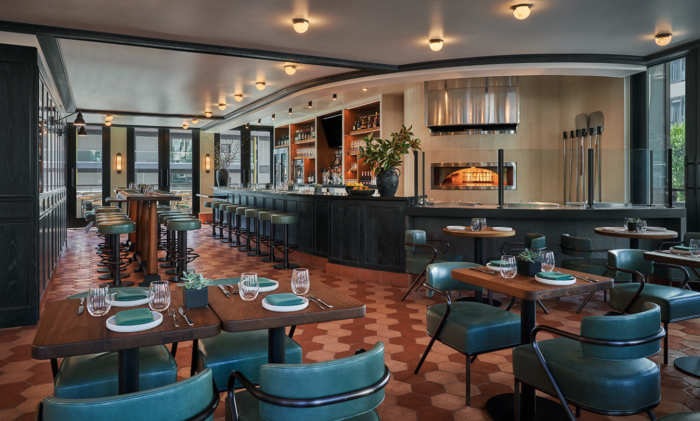 An indoor restaurant with bar and table seating.