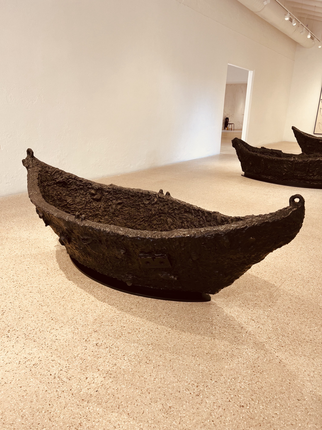 Three bronze boat sculptures.