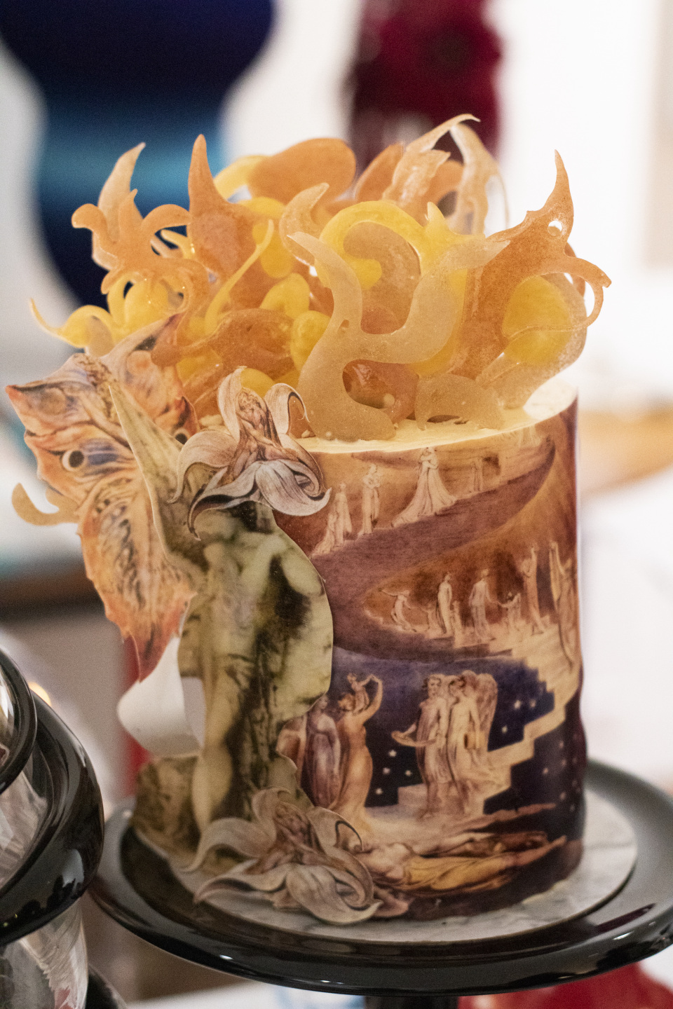 An intricate cake with art of people walking down stairs on it.