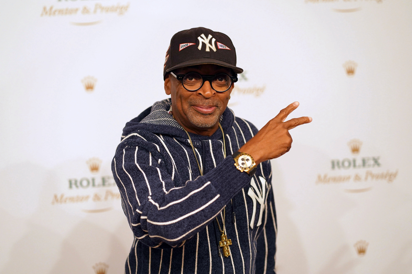 Spike Lee holding up a peace sign for a photo.