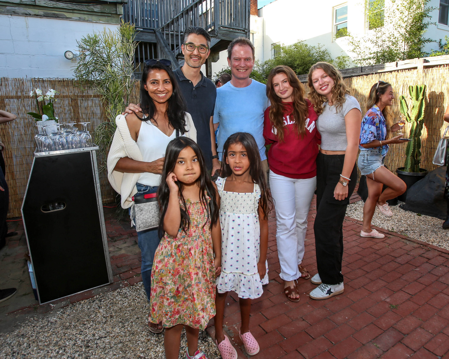 group of people poses at outdoor gallery party