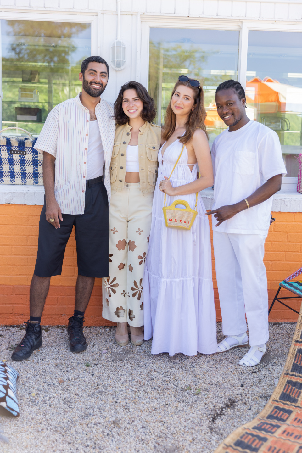 four people in white pose together