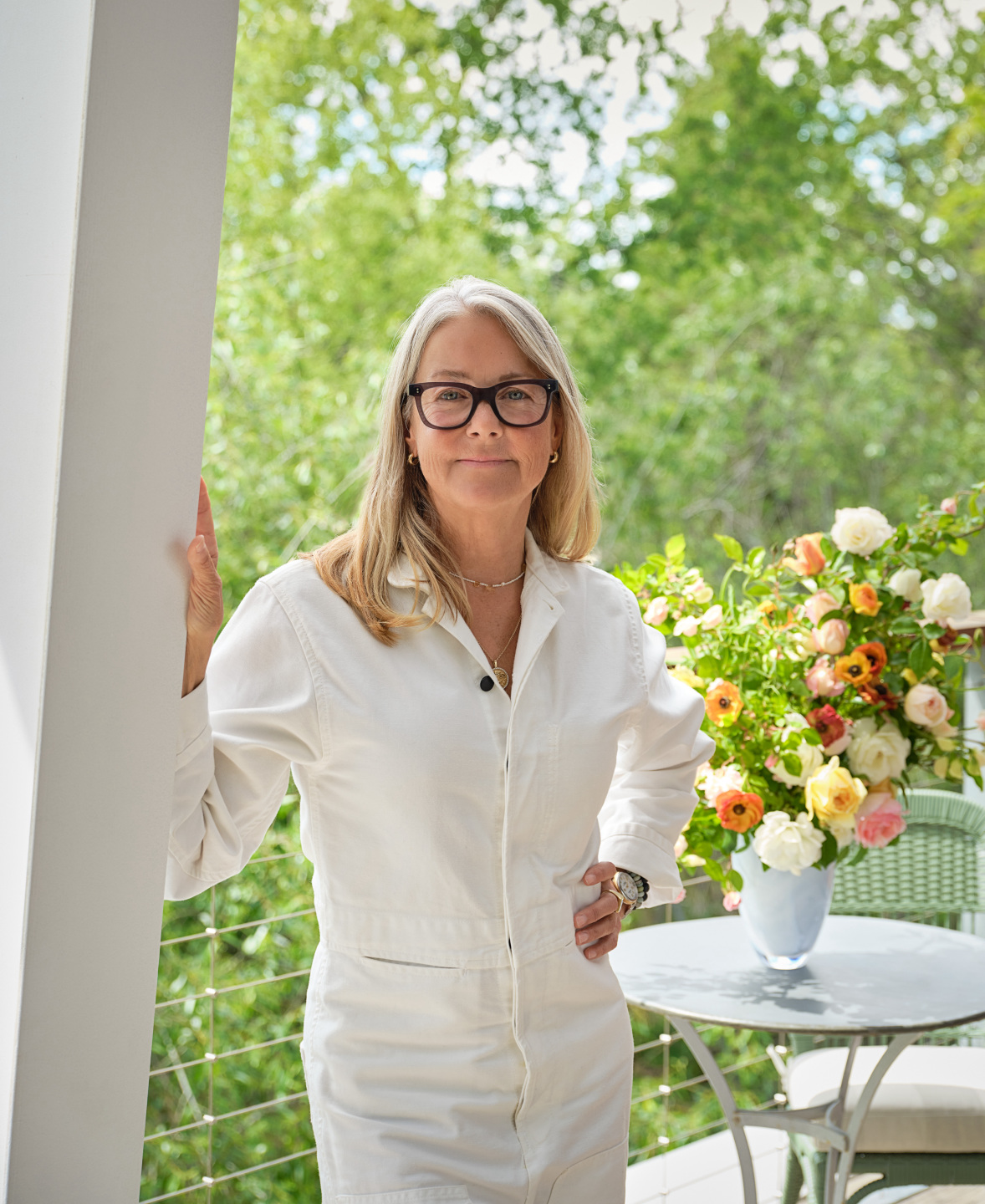 woman stands on porch