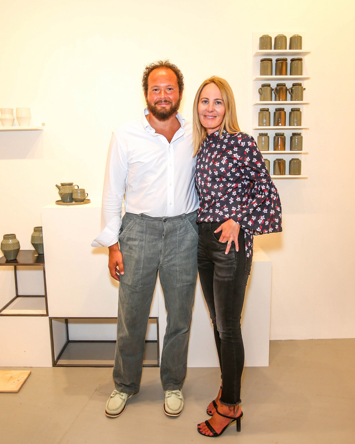 man and woman pose for photo inside art gallery