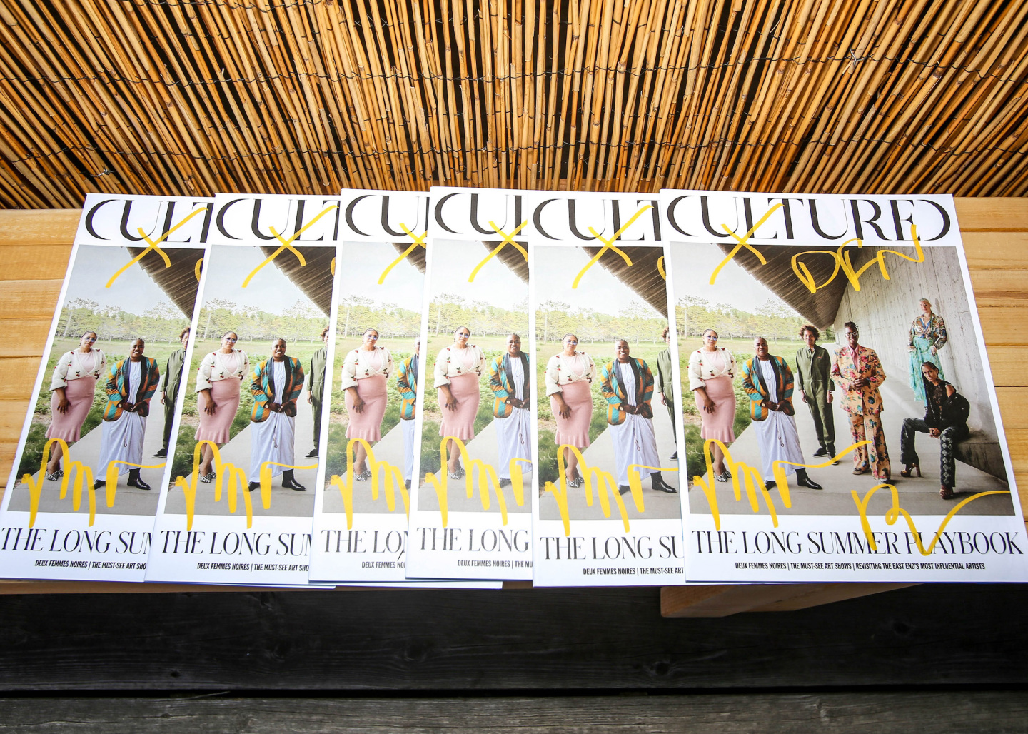 copies of cultured magazine on a wooden table