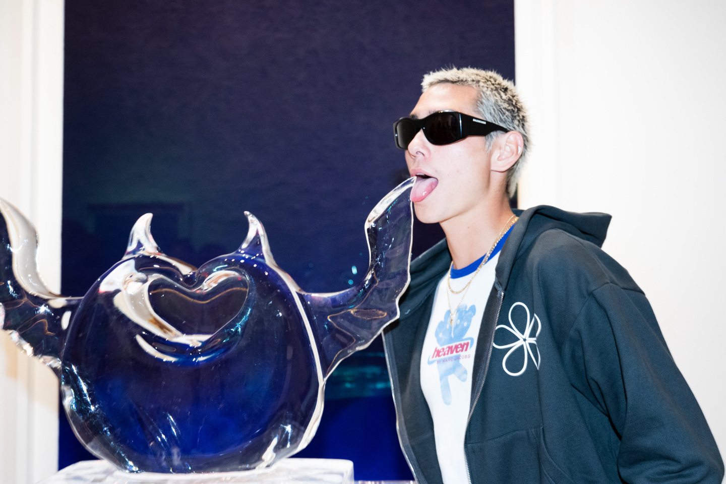 Man in sunglasses posing with an ice sculpture.