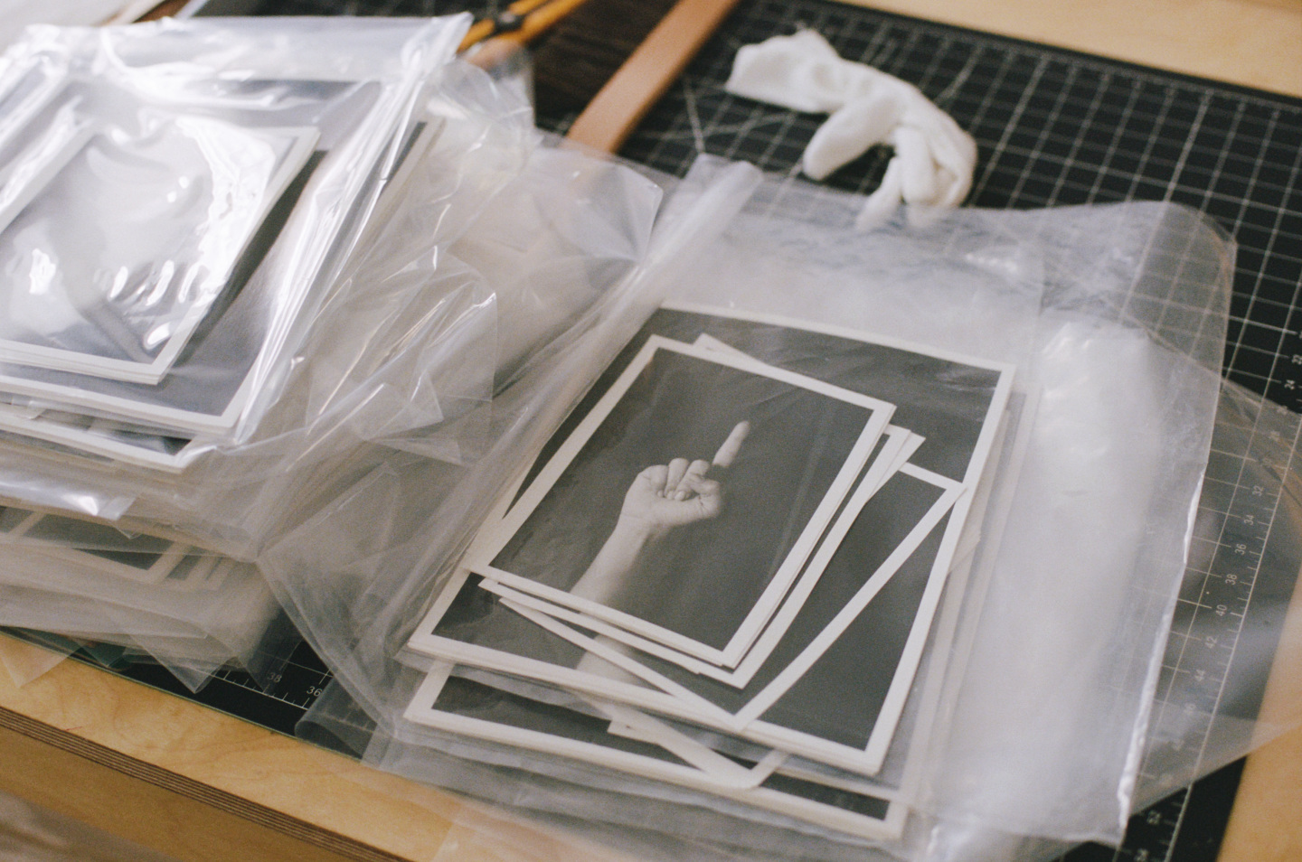 Photo of a pointing finger in a plastic wrap on desk