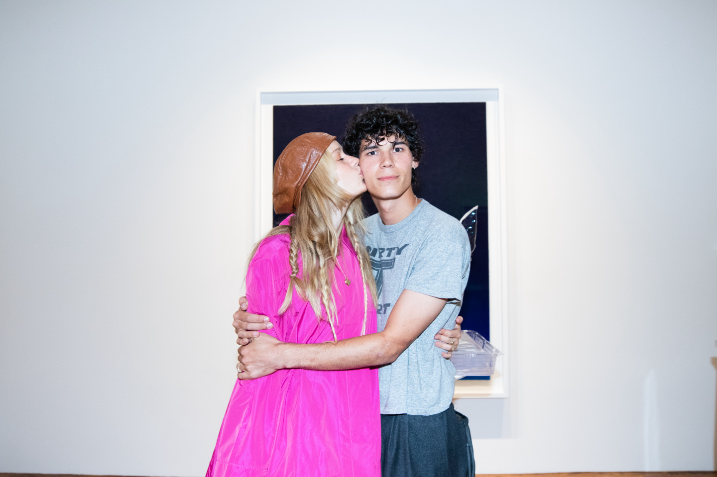 A woman kissing a man on the cheek.