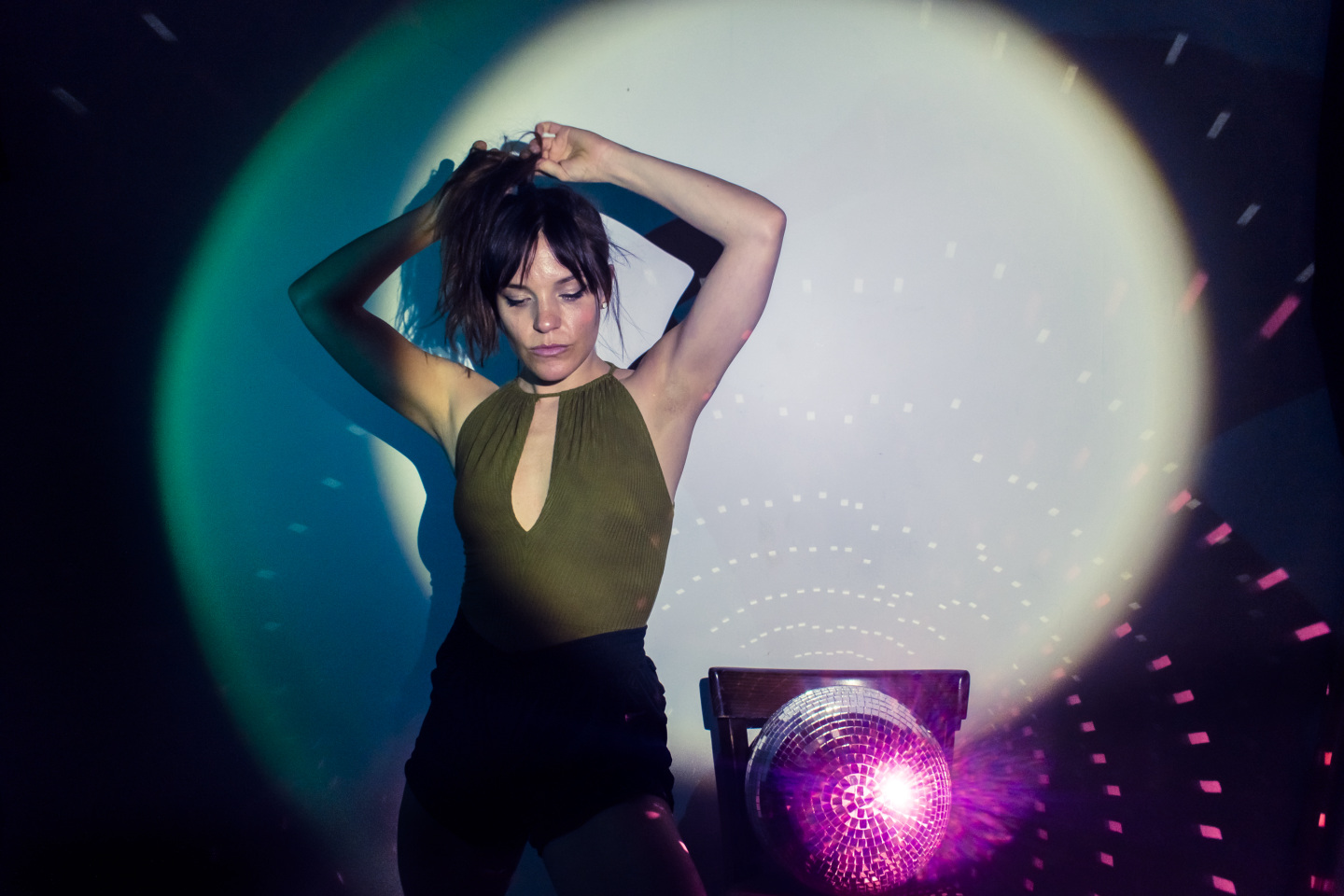 Woman stands in a spotlight