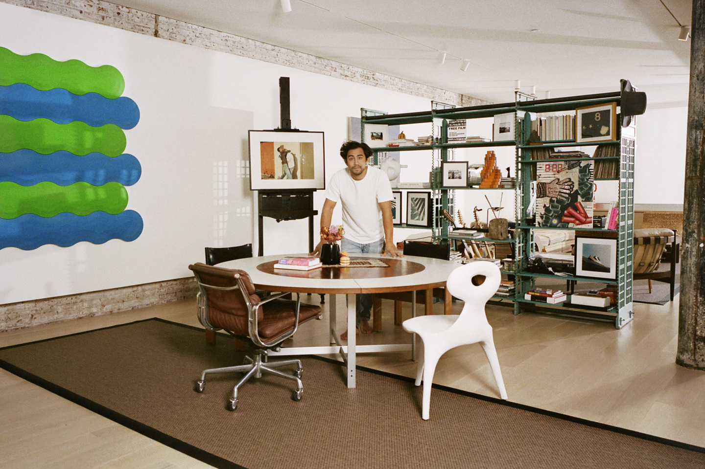 man standing over round table