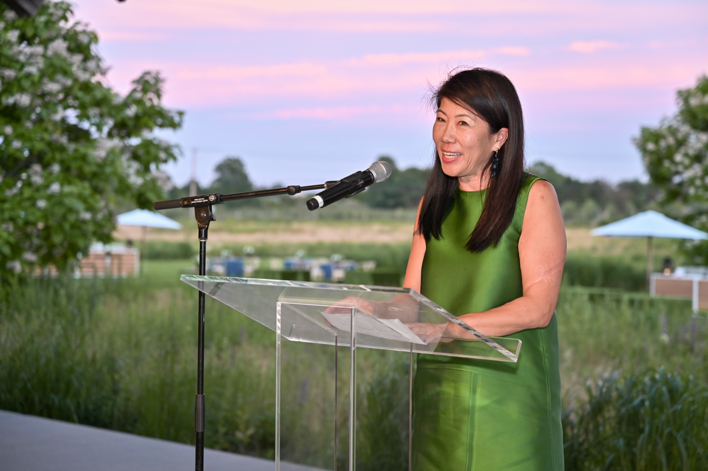 Woman stands with microphone