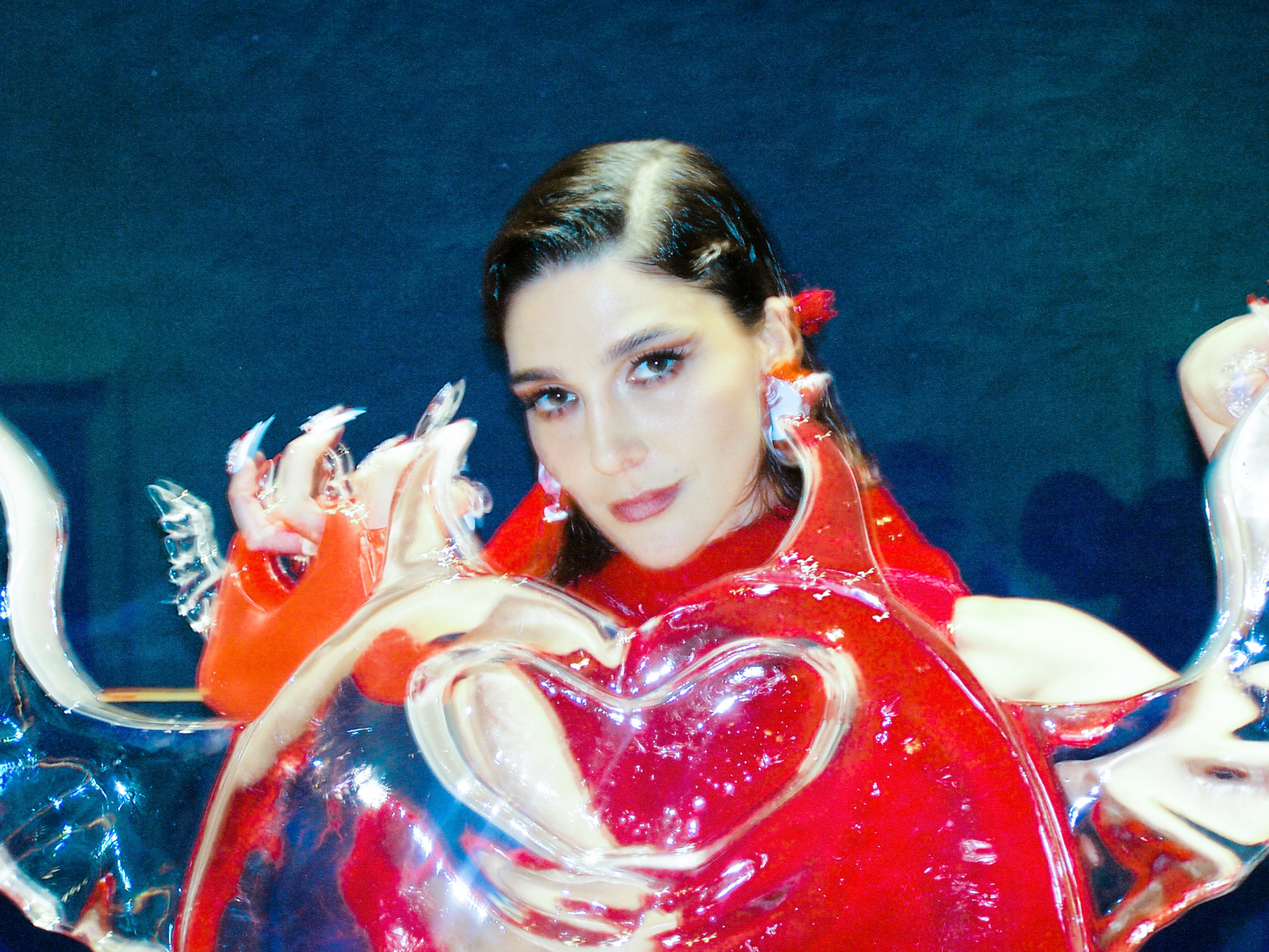 Woman standing behind an ice sculpture.