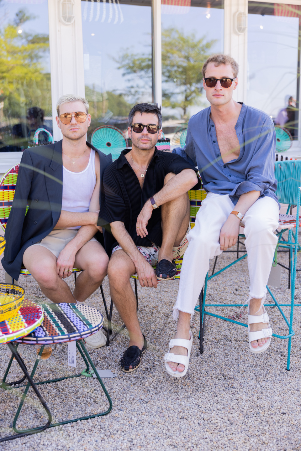 three men sit in adjacent chairs