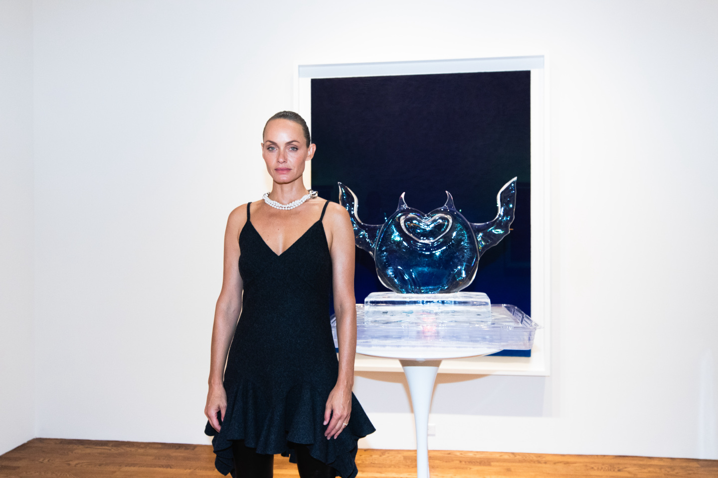 Woman standing with an ice sculpture.