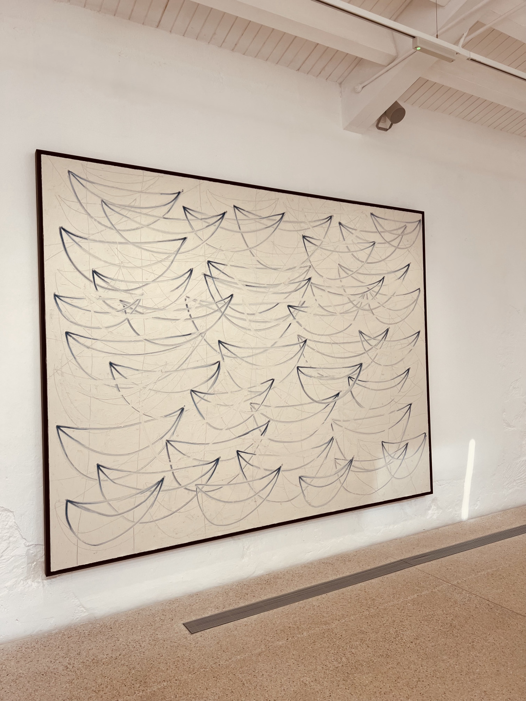 Painting of blue boats over white canvas.