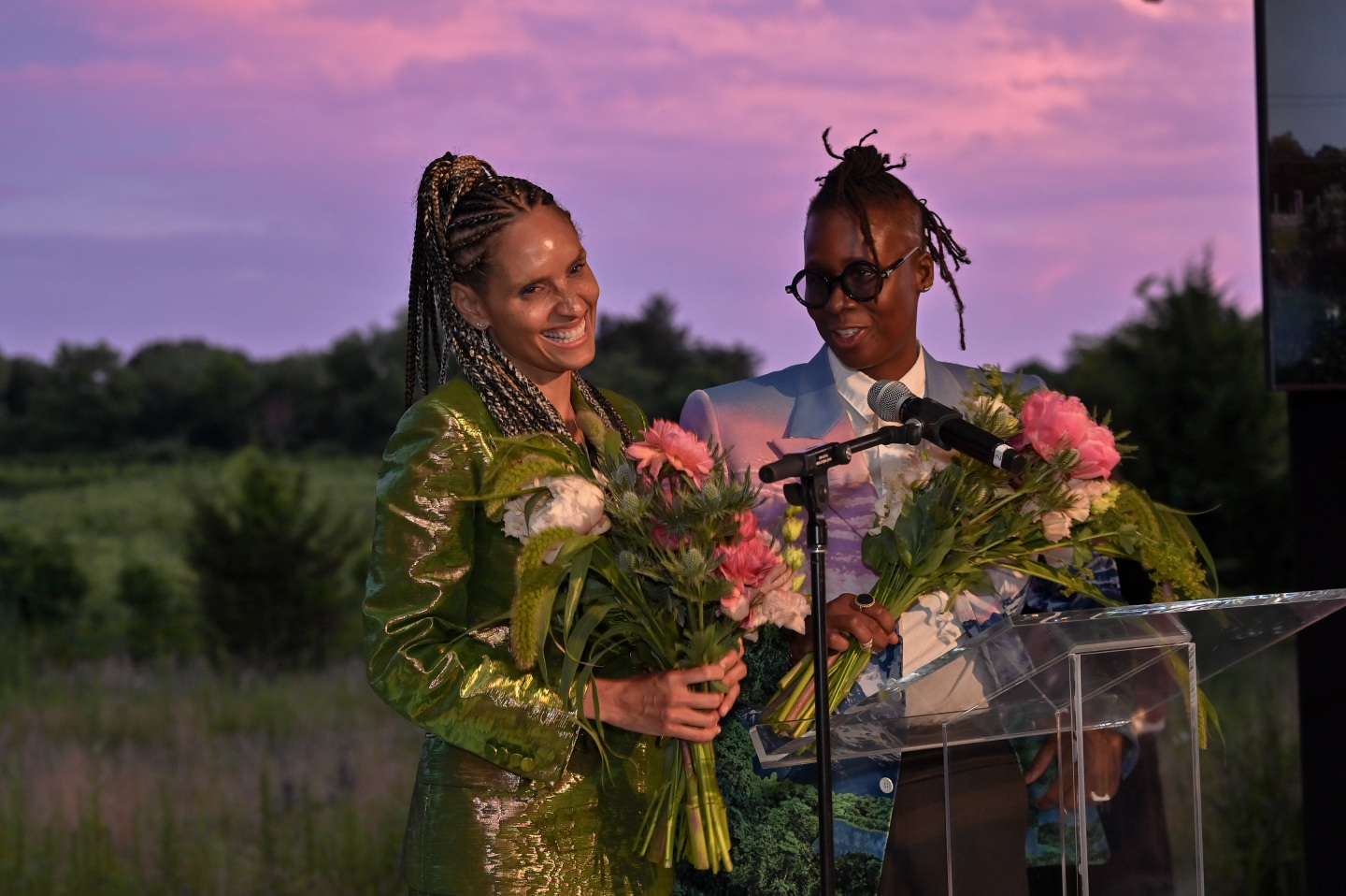 Two guests hold flowers