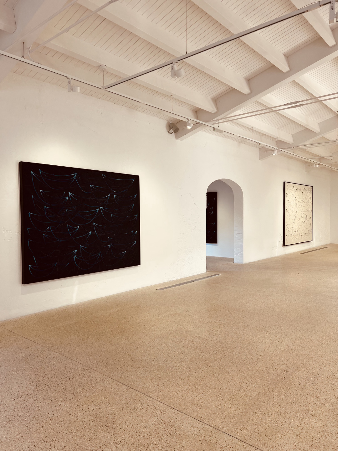 Two paintings in a gallery.