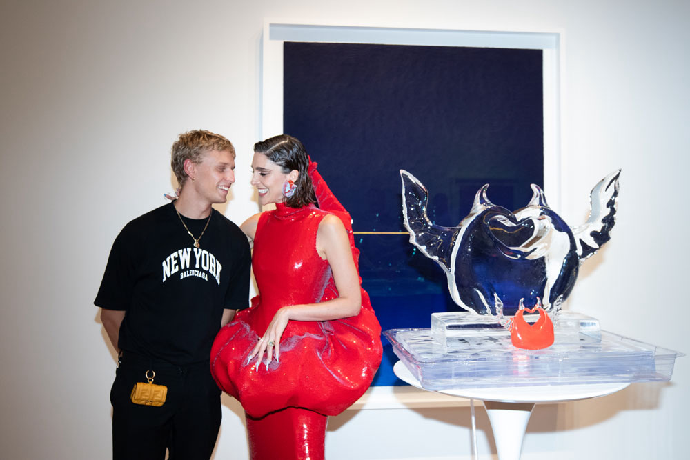 Co-founders of HEVEN Peter Dupont and Breanna Box standing next to an ice sculpture.