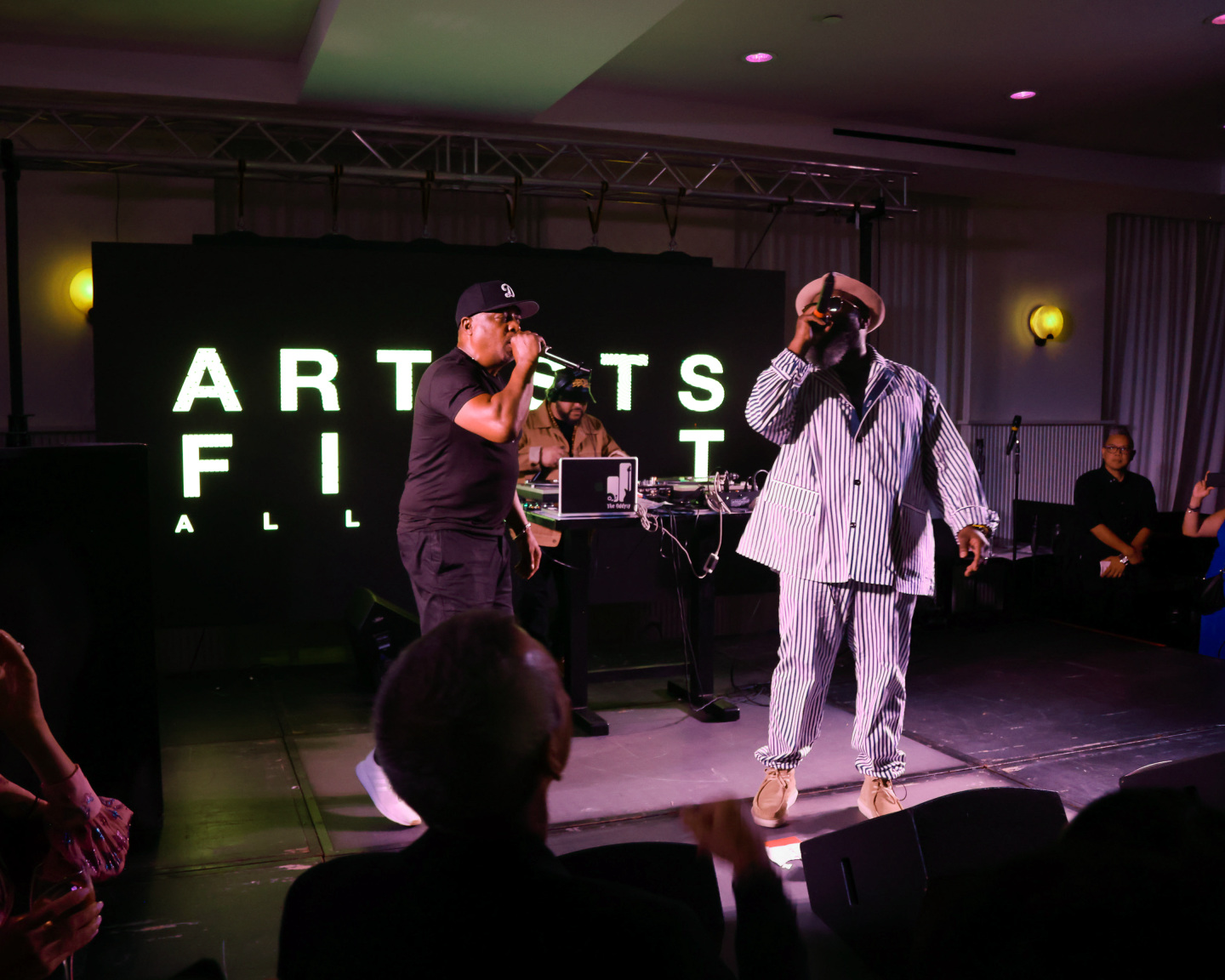 Two men on stage performing.