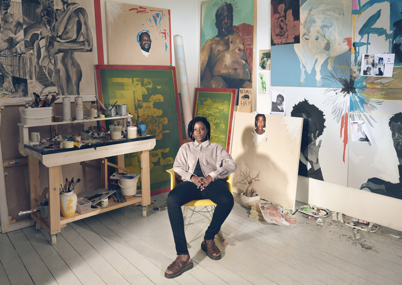 woman in studio with paintings