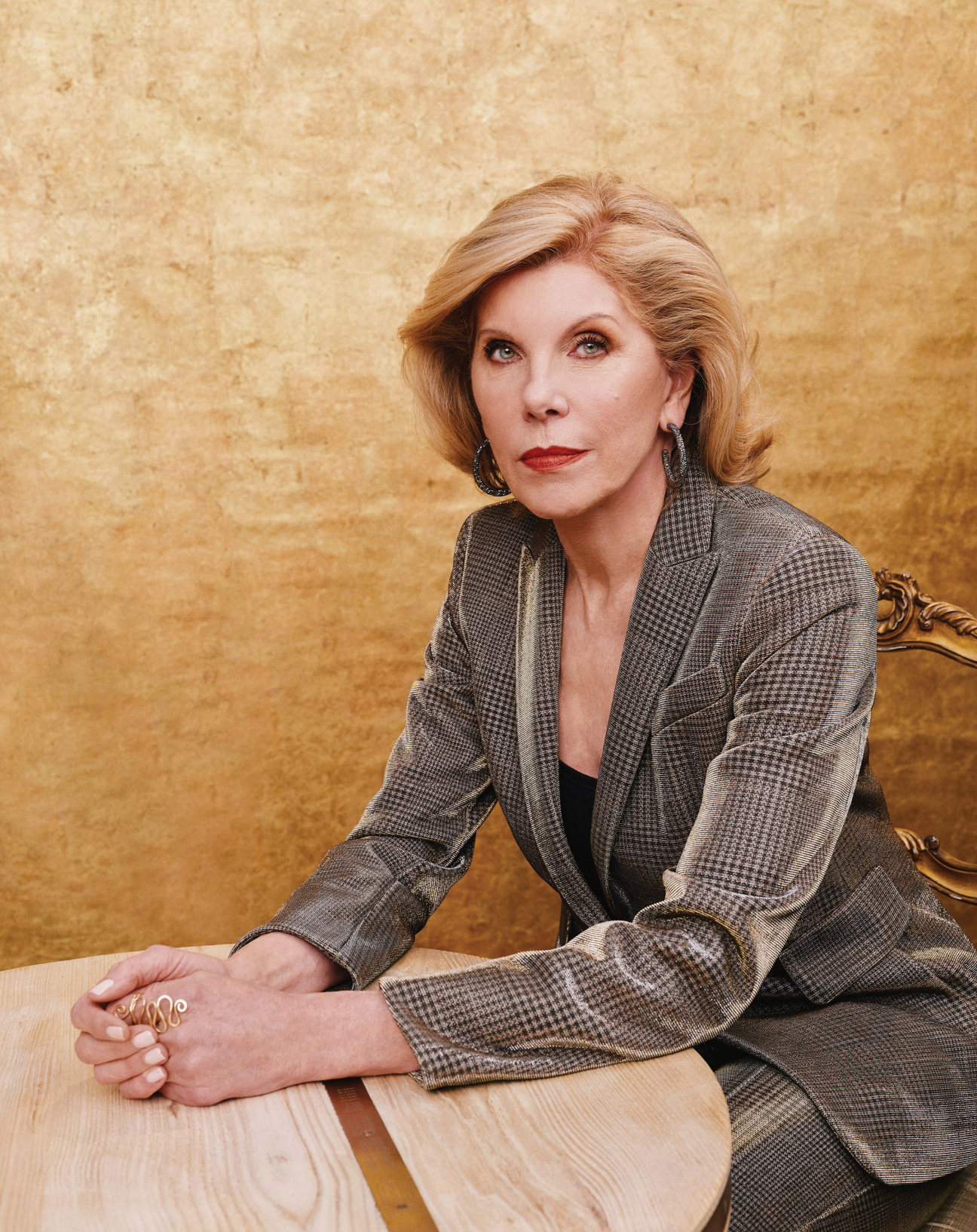 A woman sitting with her hands on the table.
