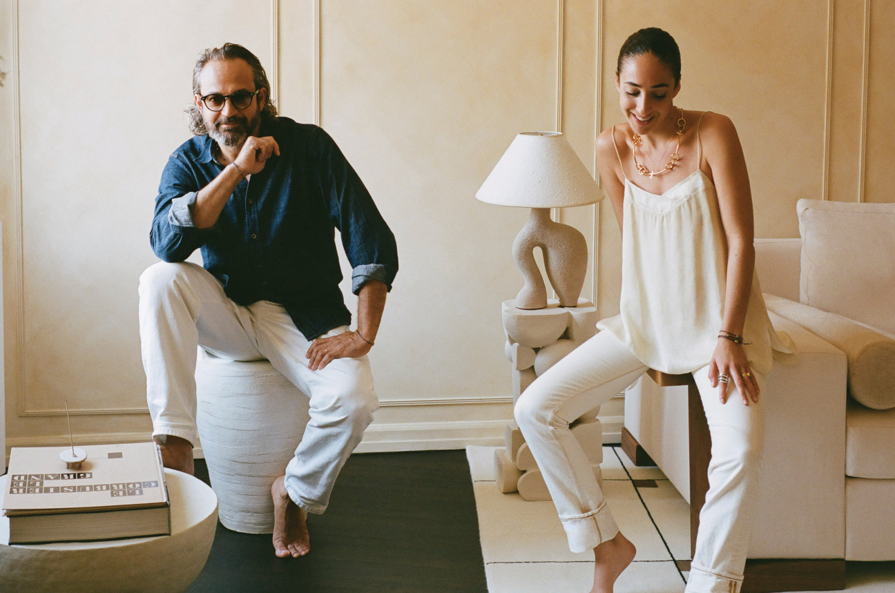 A man and woman sitting in a stylish living room.