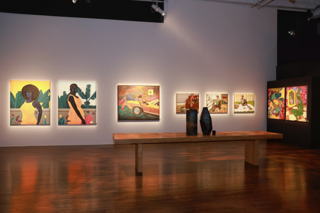 exhibition shot of paintings hanging on wall