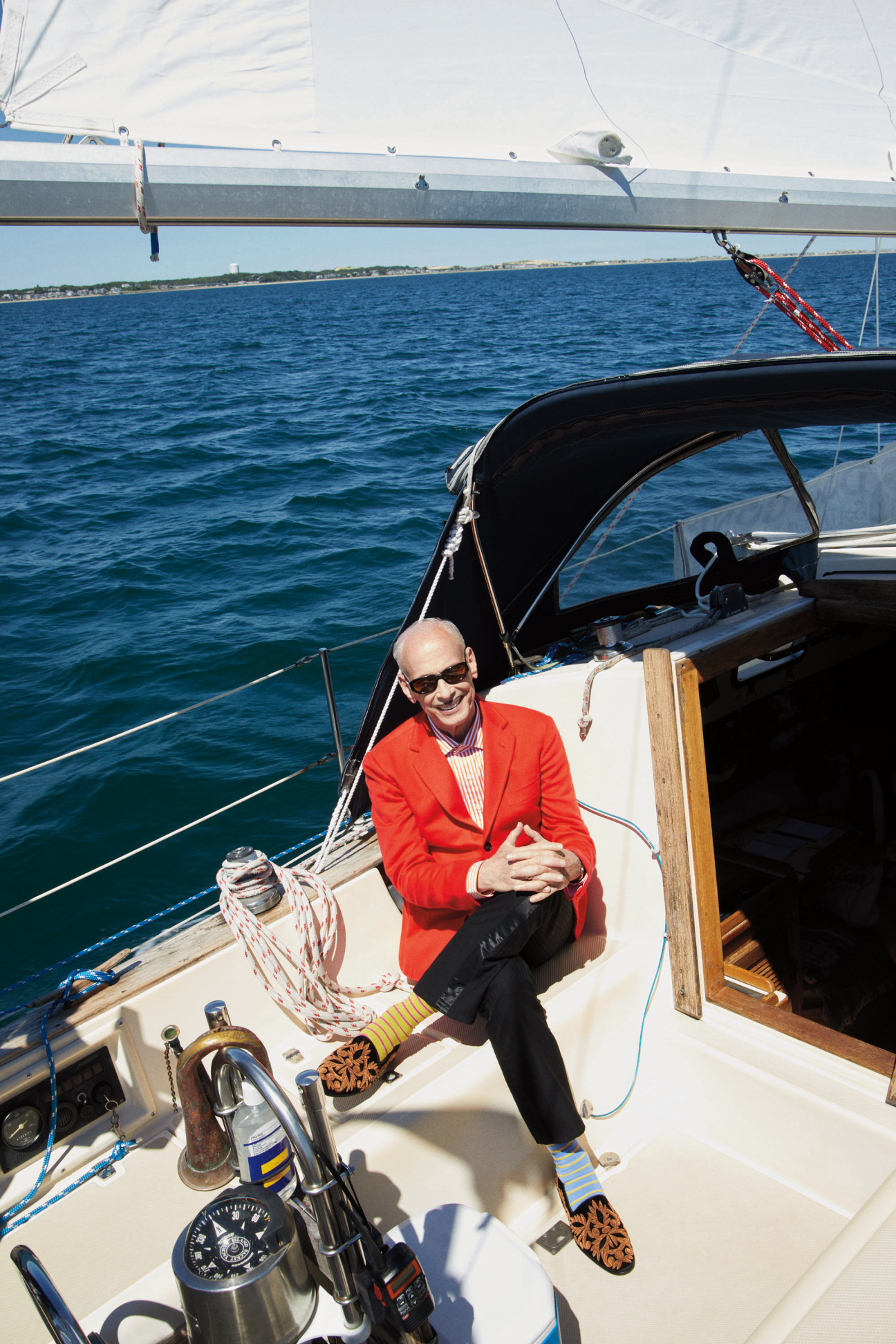 A man sitting on a sailboat.