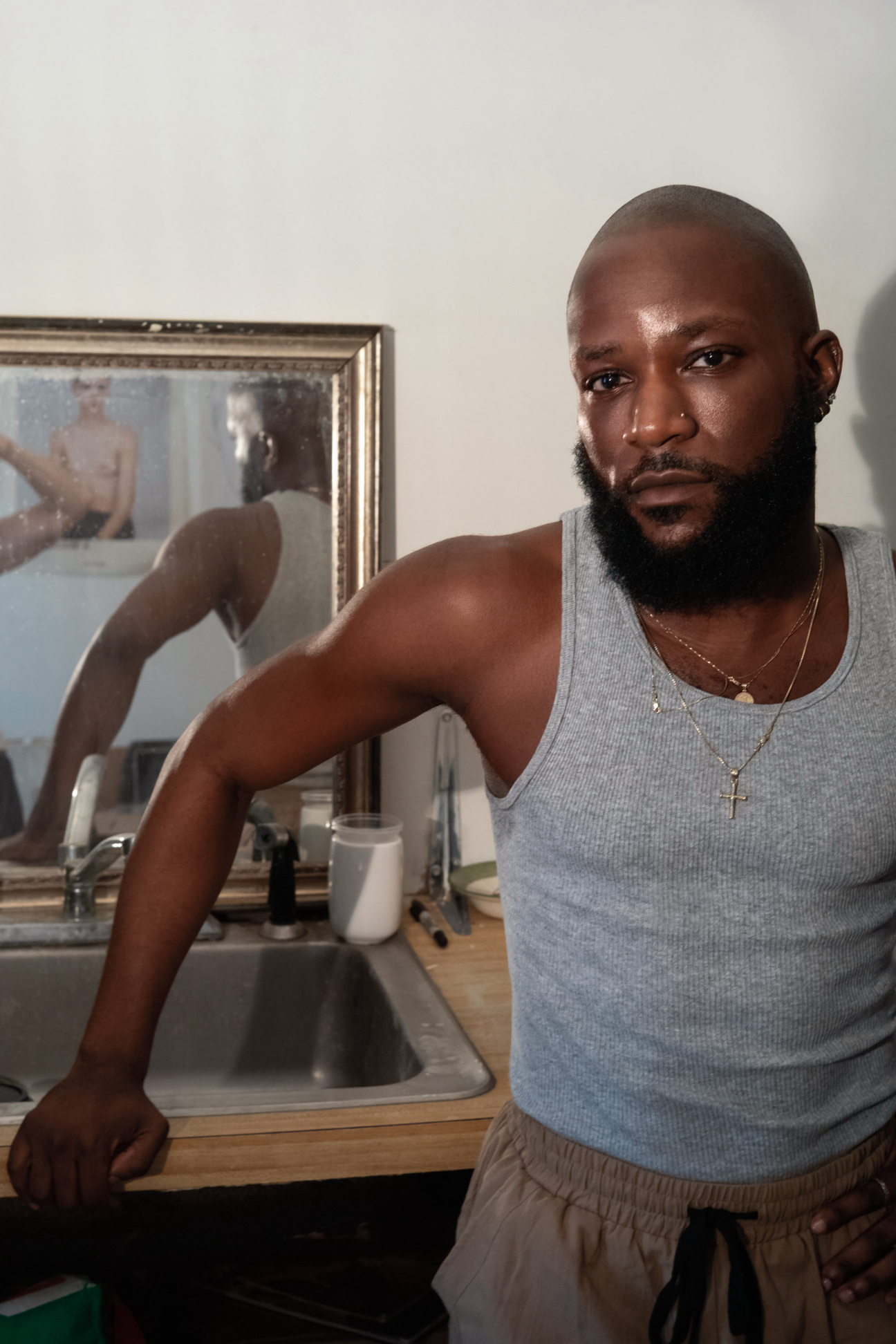 A man standing in front of a mirror posing for a photo.