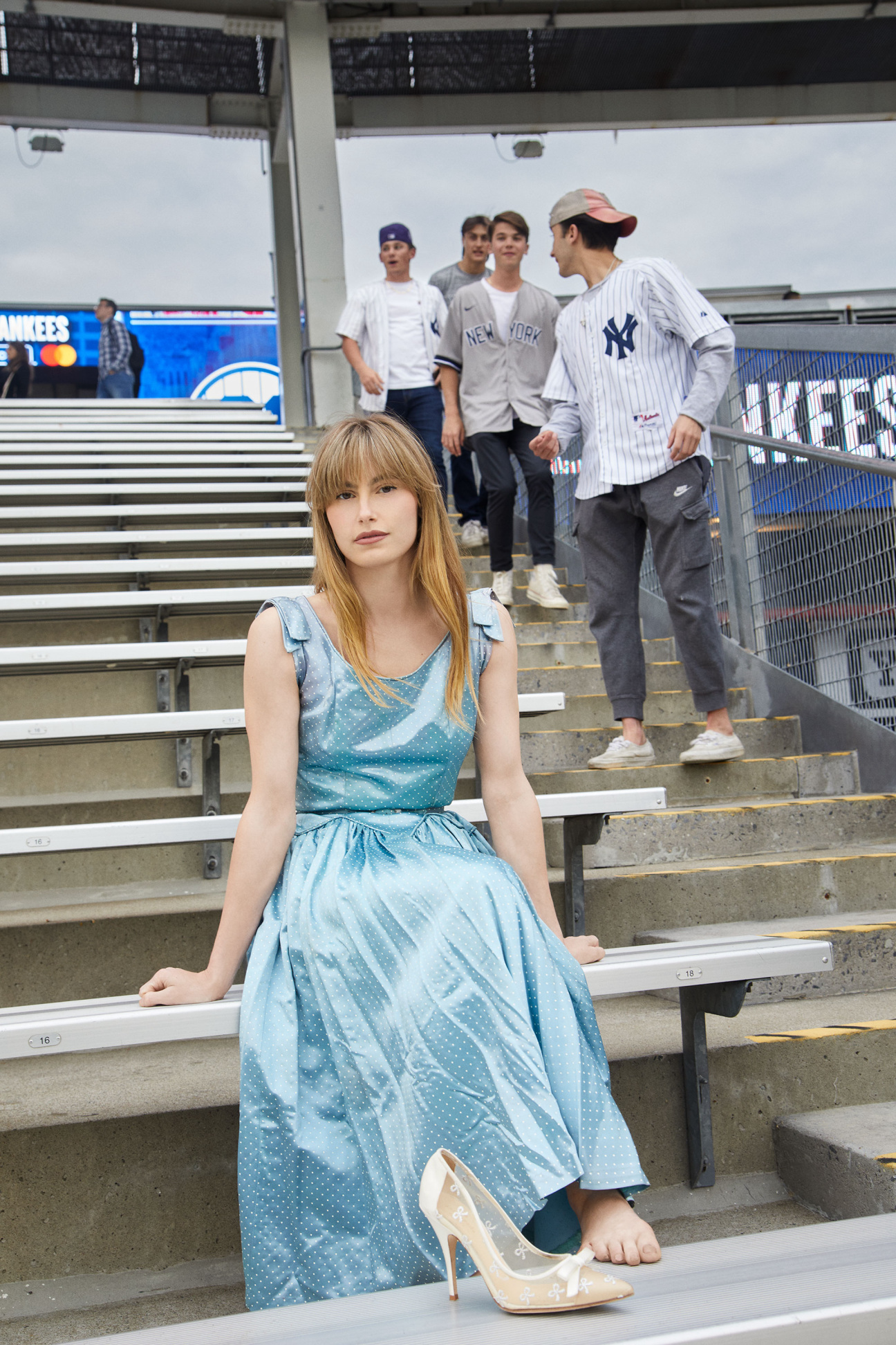 woman sitting in bleachers