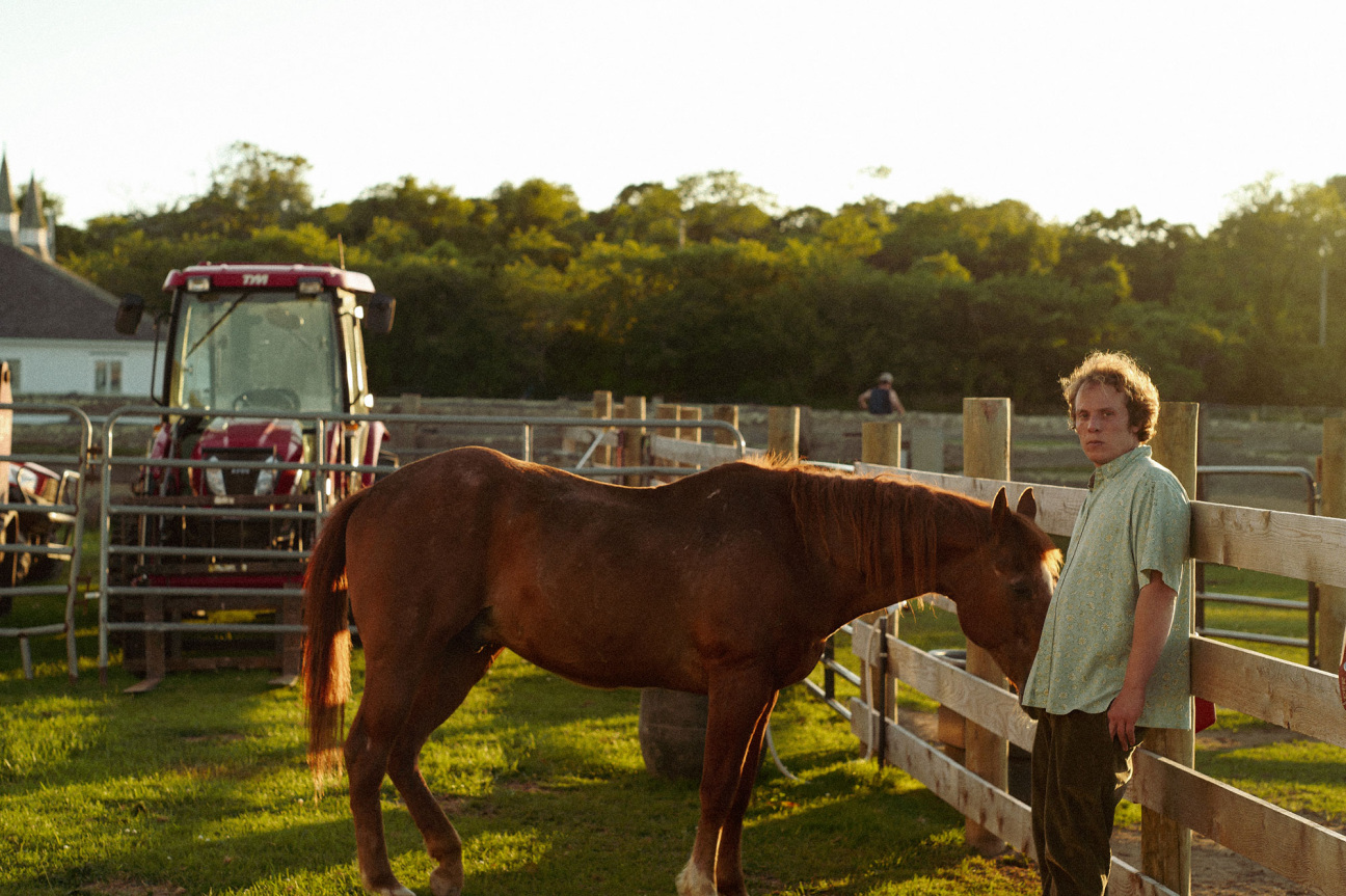 Man stands beside a horse