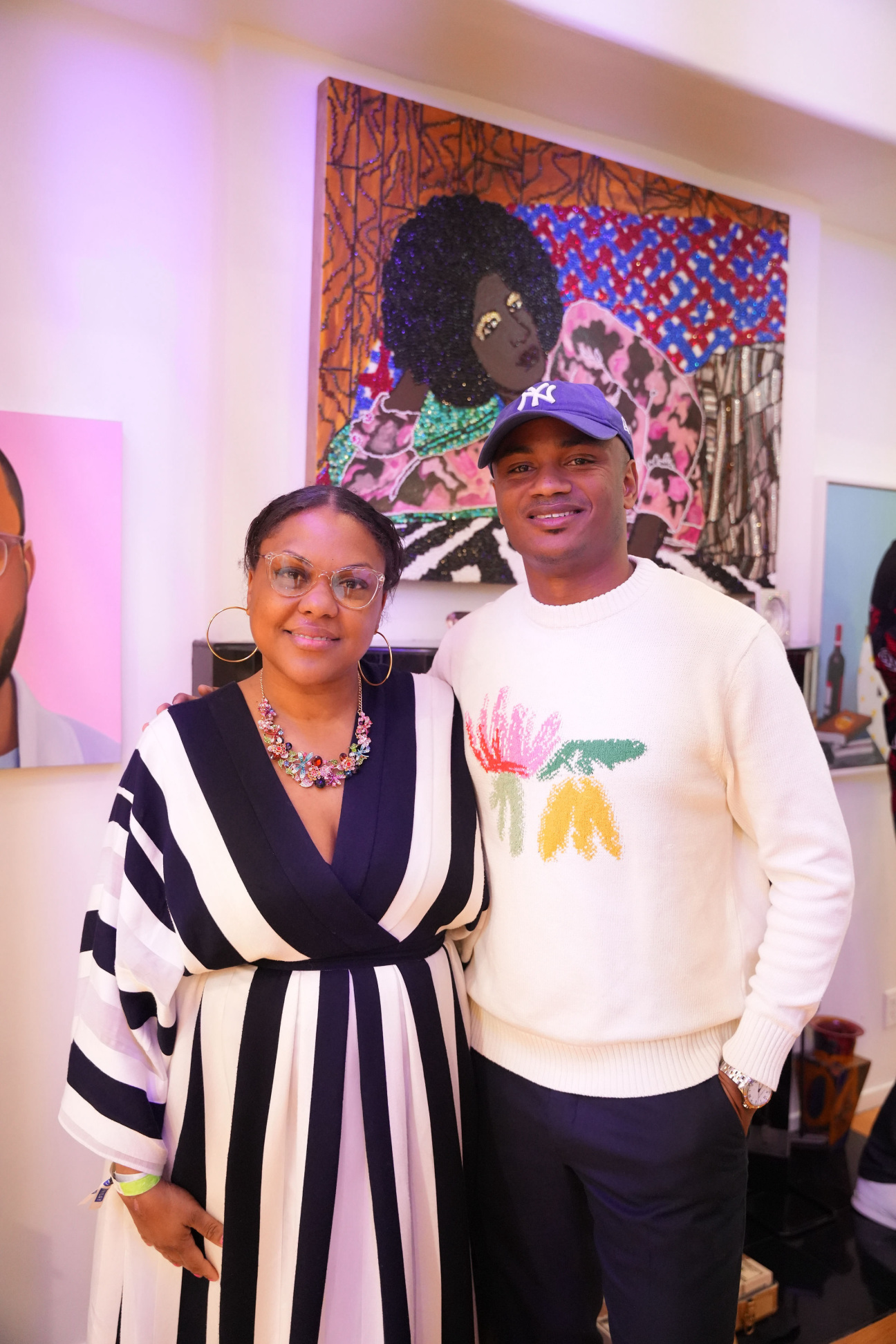 Dominique Clayton and Thomas Moore with artwork by Mickalene Thomas