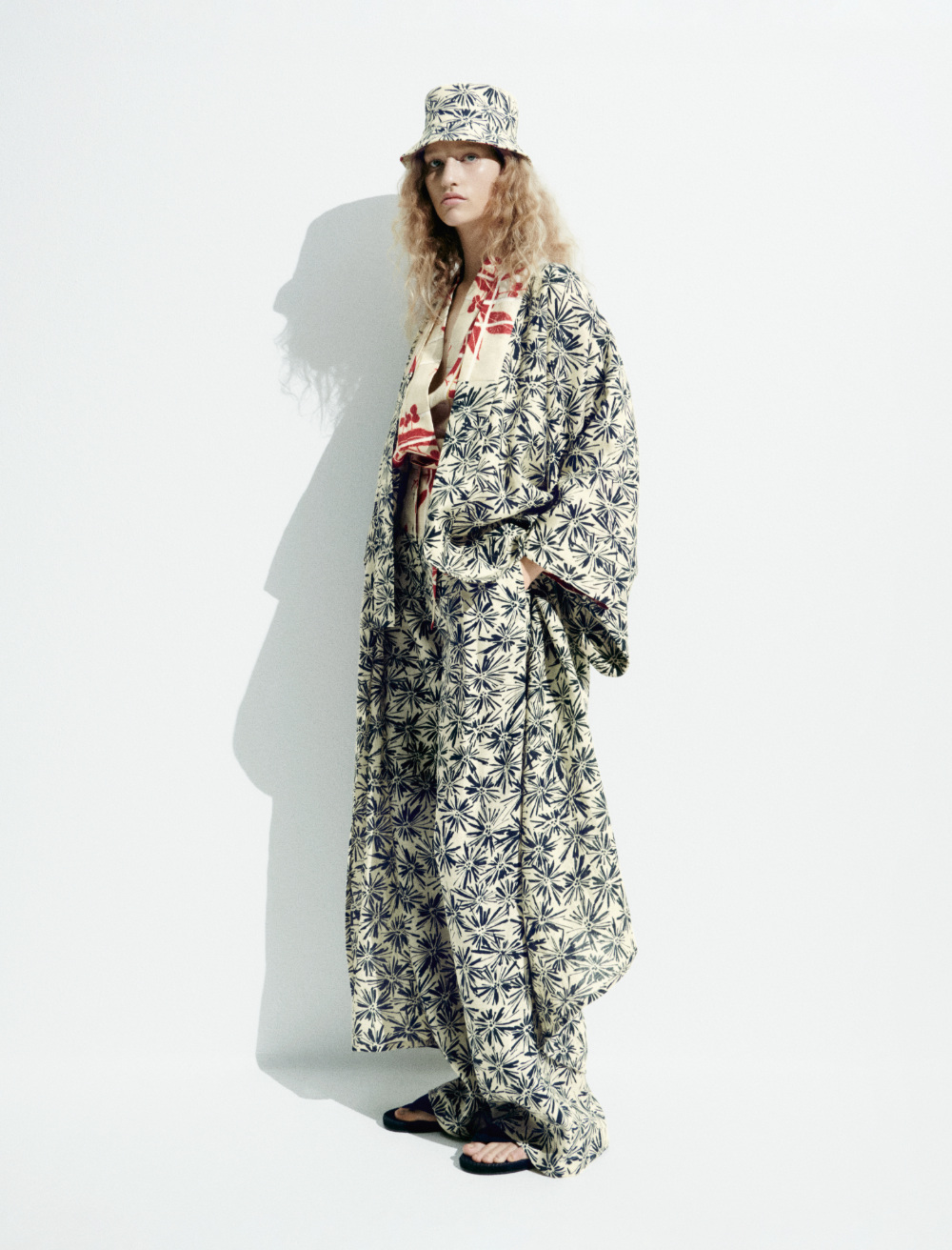 Blonde woman in a gray cape