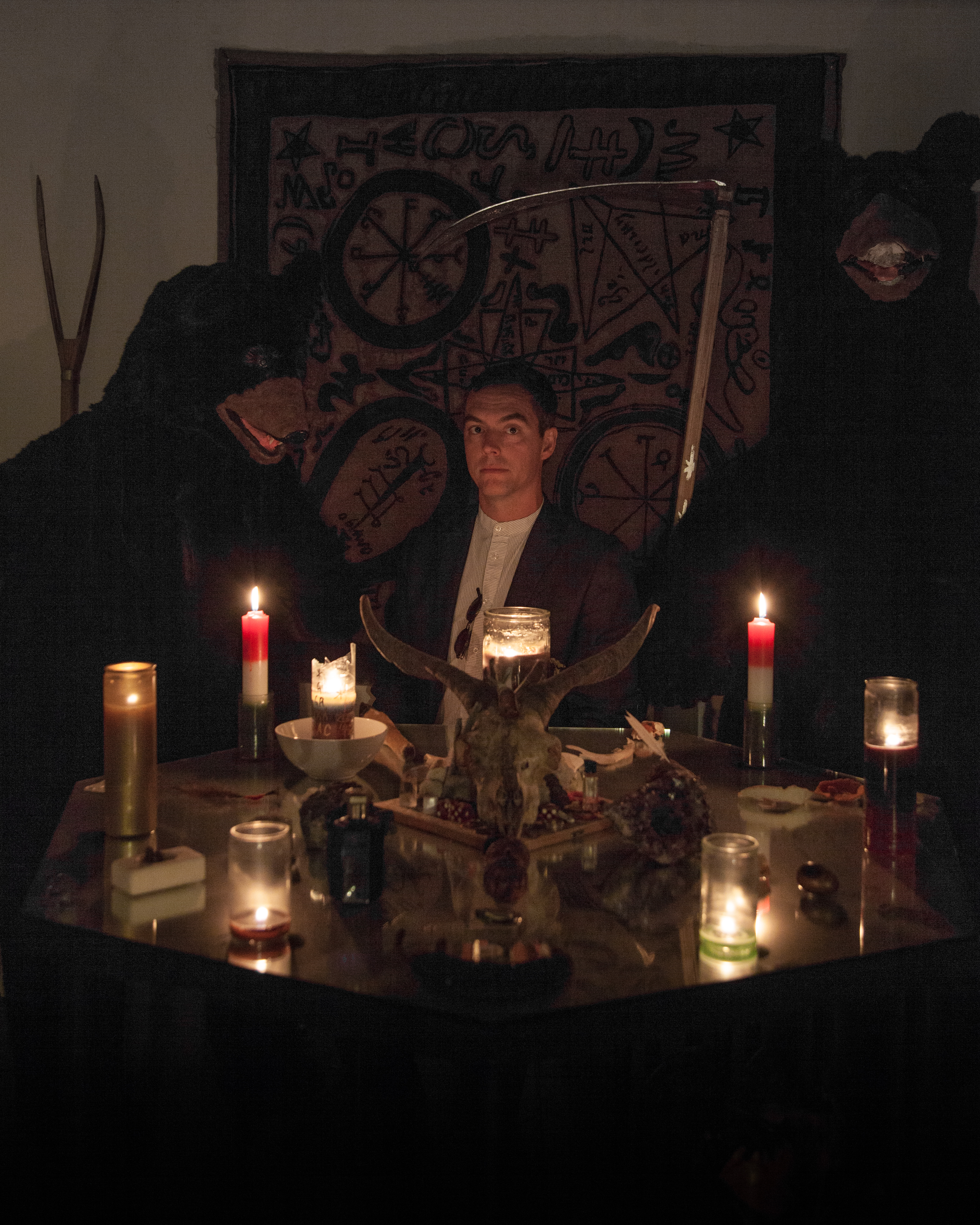 Aaron Moulton in studio of the artist Lazaros, where he holds readings and rituals, in addition to his visual art practice. Portrait by Lazaros.