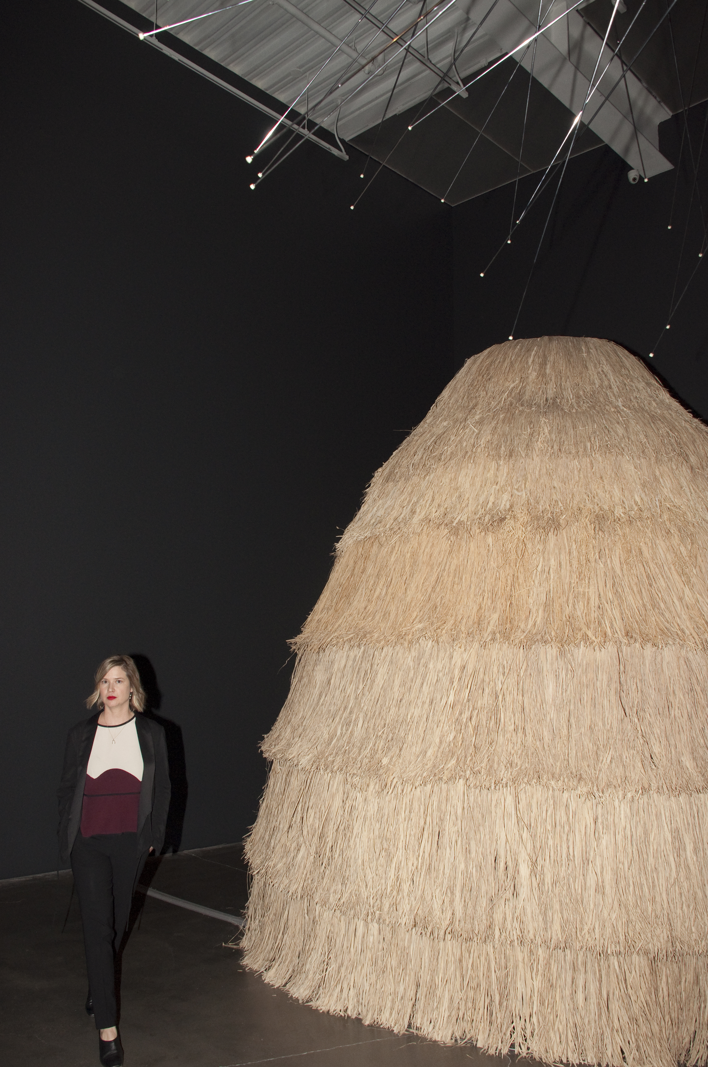 Johanna Burton standing next to a detail of Simone Leigh’s Signs and Grips (2017), one of the works on view at New Museum’s “Trigger: Gender as a Tool and a Weapon.” 