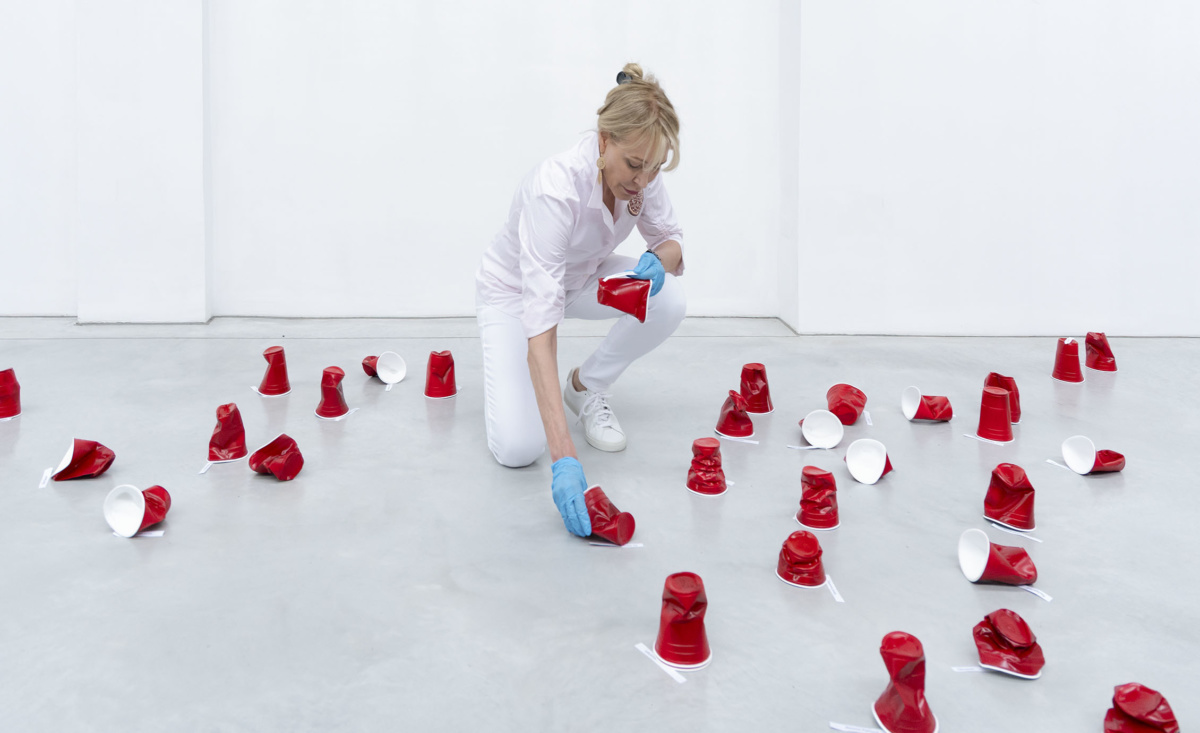 Paula Crown  installing “The Architecture of Memory” at a 2,200-square-foot former glass factory in Venice. The preciously crafted ceramic replicas of disposable cups are a comment on consumer waste. Courtesy of PAHC/Studio.