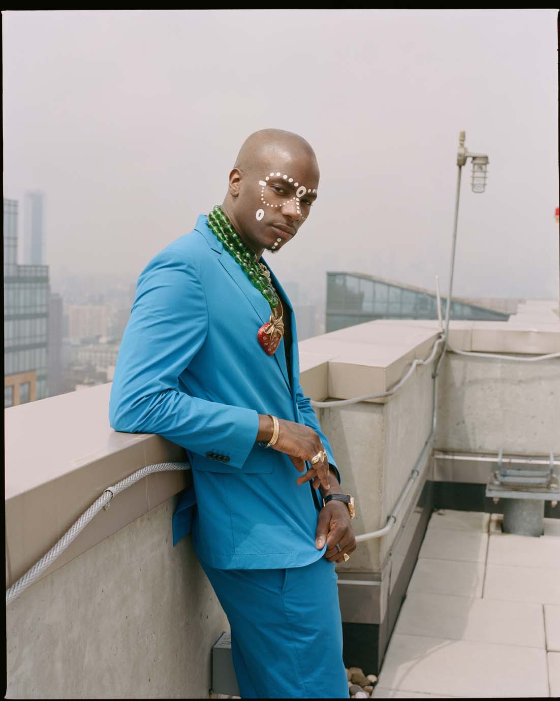 Styled by Oluwabukola Becky Akinyode.  Young Paris wears a Boss suit, Gucci strawberry brooch and beaded tiger motif necklace.