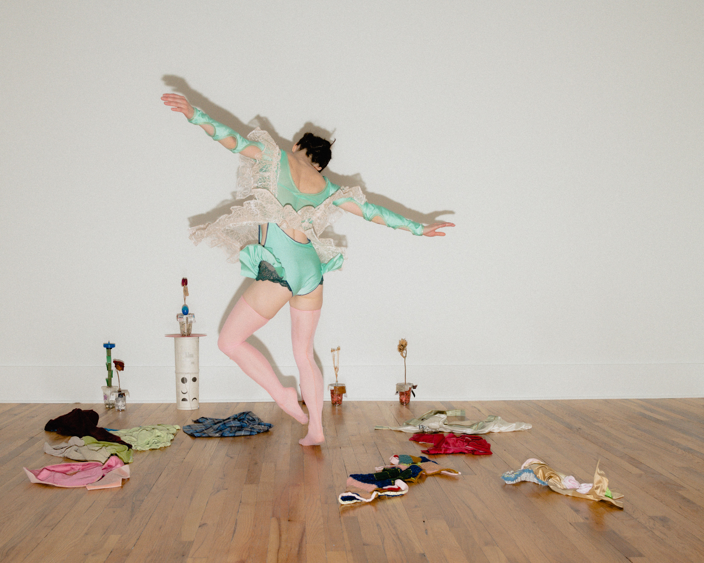 Brittany Bailey dressed in Lou Dallas Resort 2020 dances betwixt sculptures by Andrew Gonzalez. 