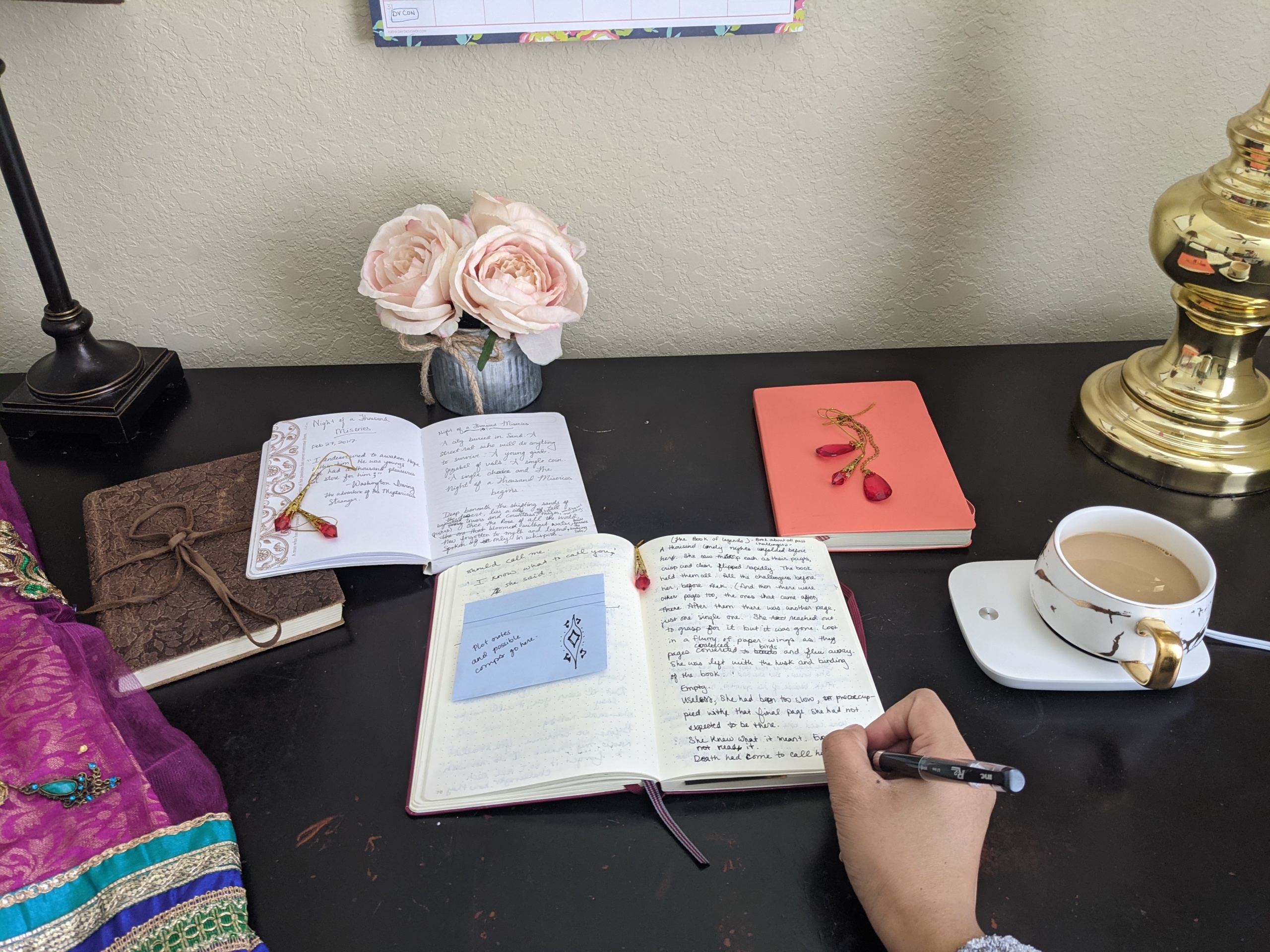 The desk of writer C.J. Hamilton, a student of Tomi Adeyemi's  #WritersRoadmapxValentino writing workshop. Photo courtesy of C.J. Hamilton.