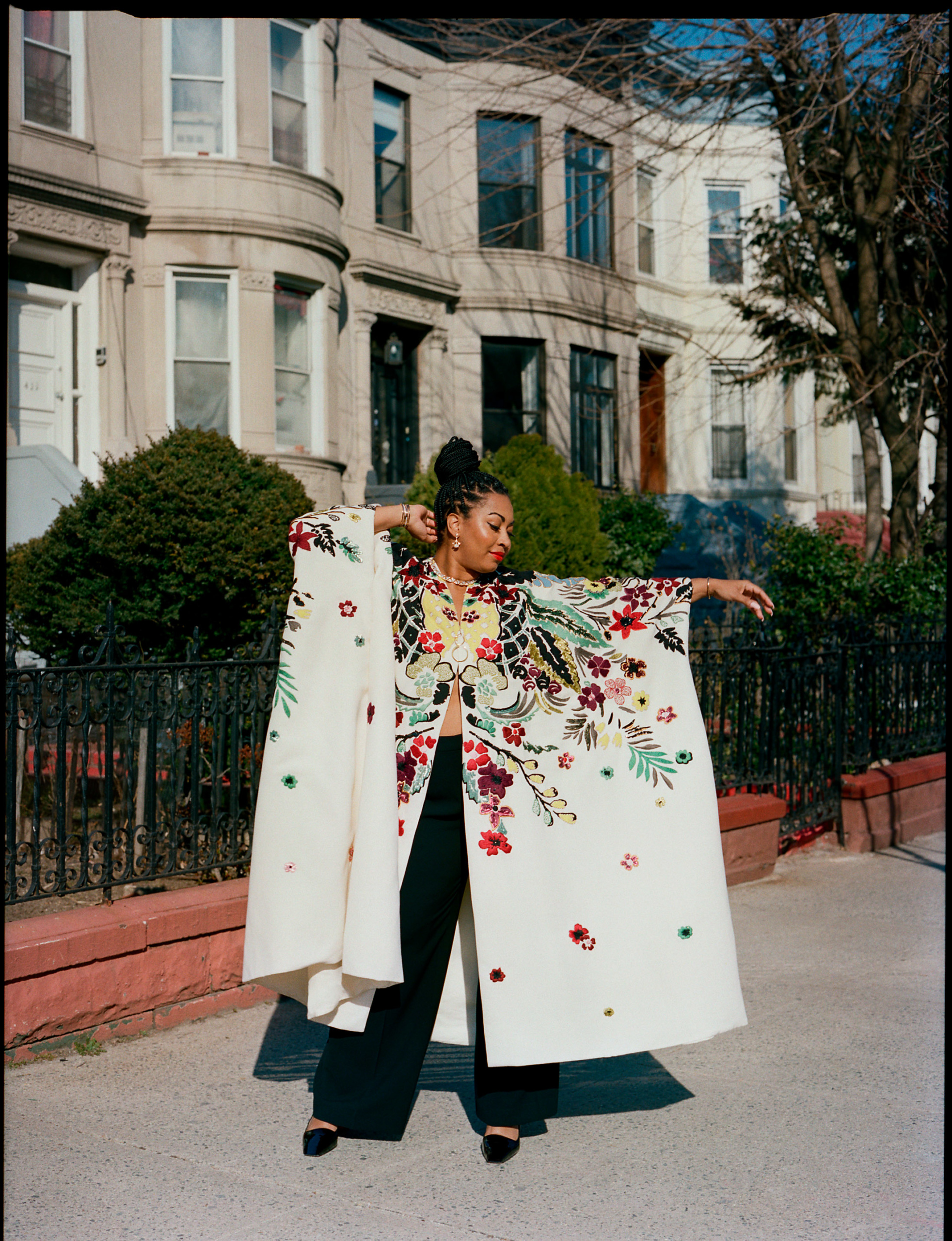 Rachel Cargle wears a Valentino robe, pants by Lafayette 148, shoes by Christian Louboutin and jewelry by Bulgari and Khiry. Styled by Becky Akinyode. Makeup by Jaleesa Jaikaran using Ilia Beauty.