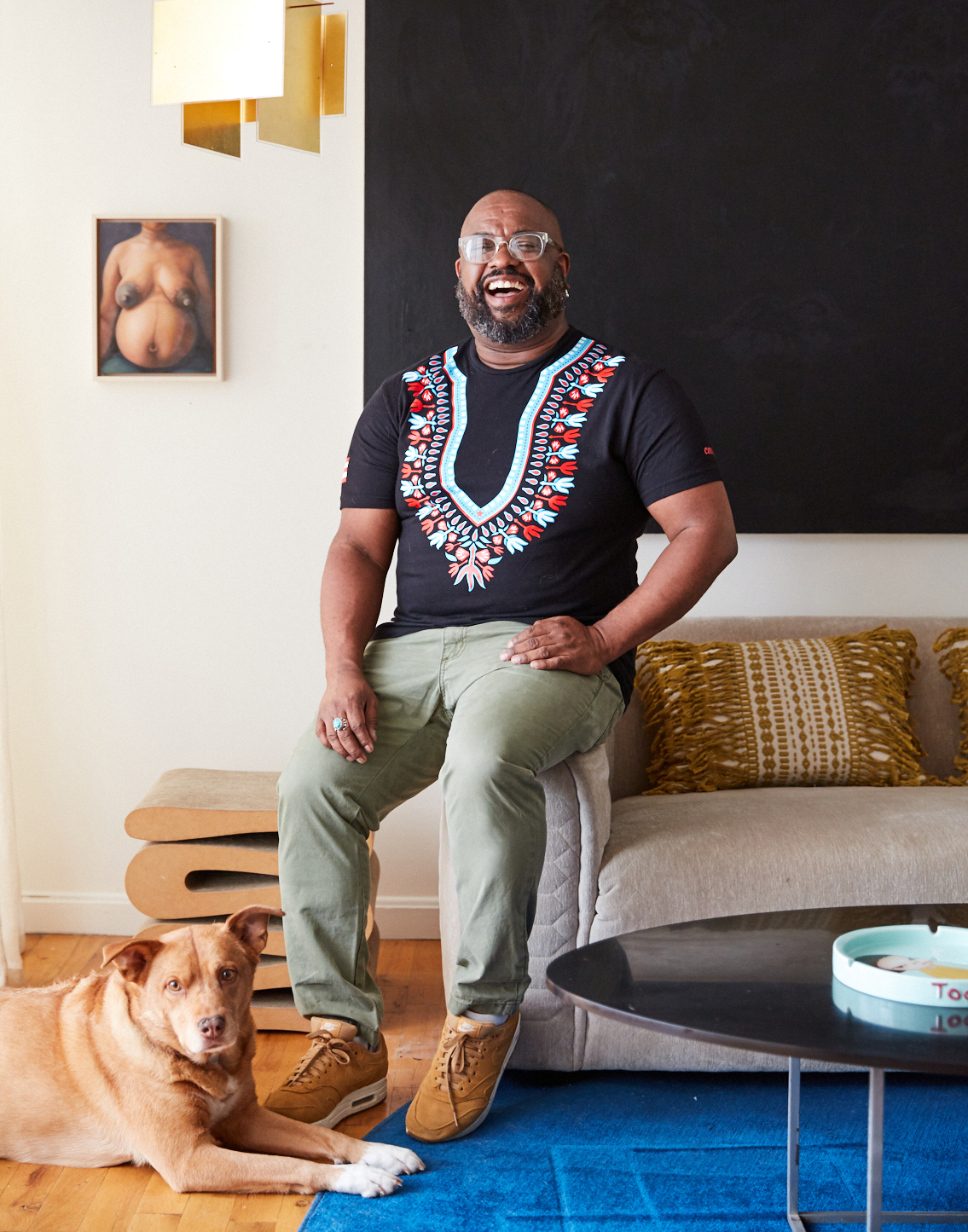 Designer Leyden Lewis in his Brooklyn loft with his dog.