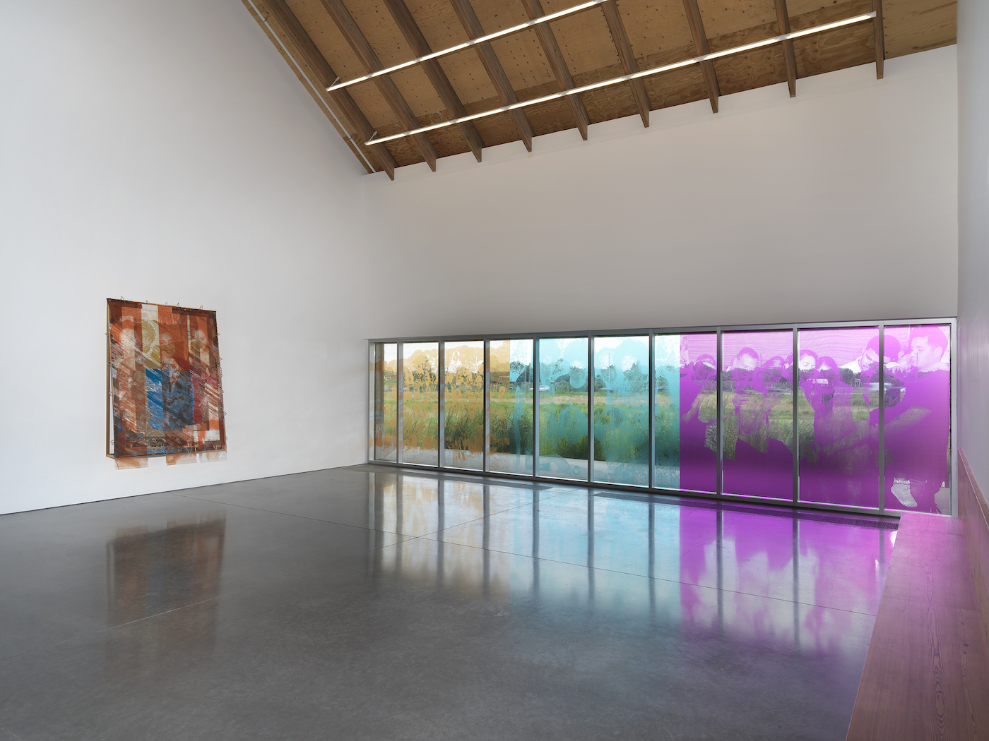 Tomashi Jackson: The Land Claim. Installation view: Parrish Art Museum, Water Mill, NY, July 11–November 7, 2021. Left to right:  The Three Sisters, 2021. Collaborative Work: Vessels of Light (From Jeremy, Juni, and Steven), 2021. Window installation with photographs by Jeremy Dennis Richard “Juni” Wingfield and Juntos, New York, USA, 2020, by Steven Molina Contreras. Photo by Dario Lasagni.