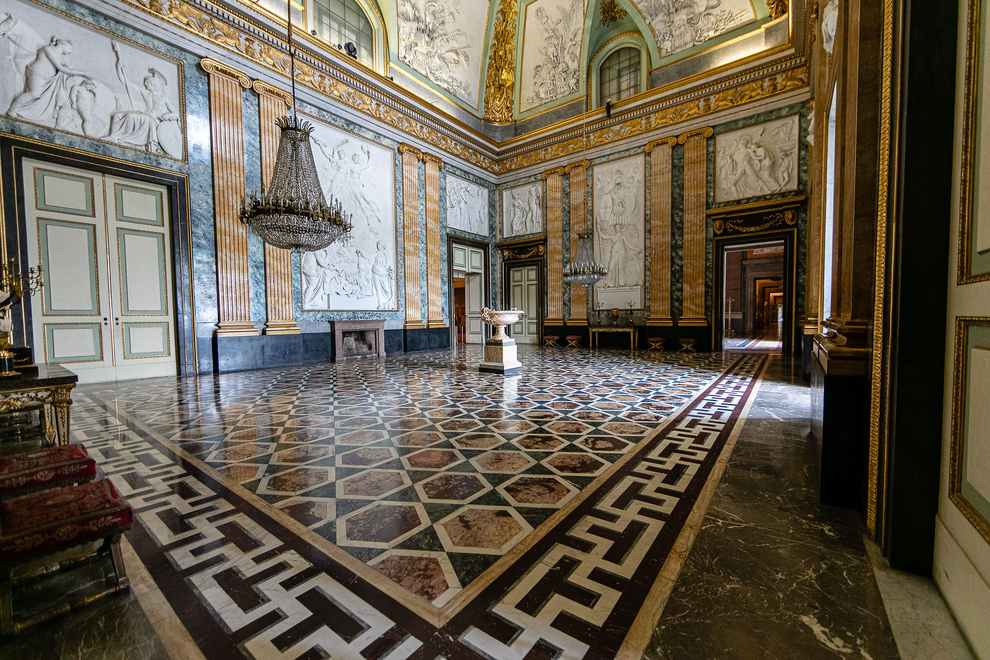 large room in royal palace of caserta with chandelier